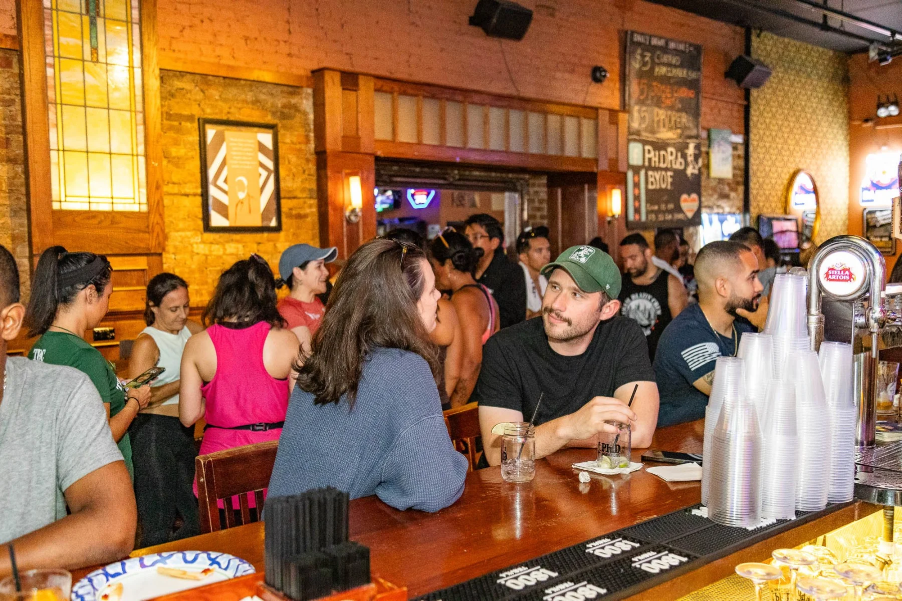 Lively bar scene with patrons enjoying drinks and conversation