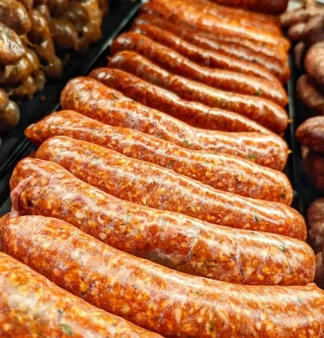 Plate of sausage and chorizo, garnished and ready to serve.