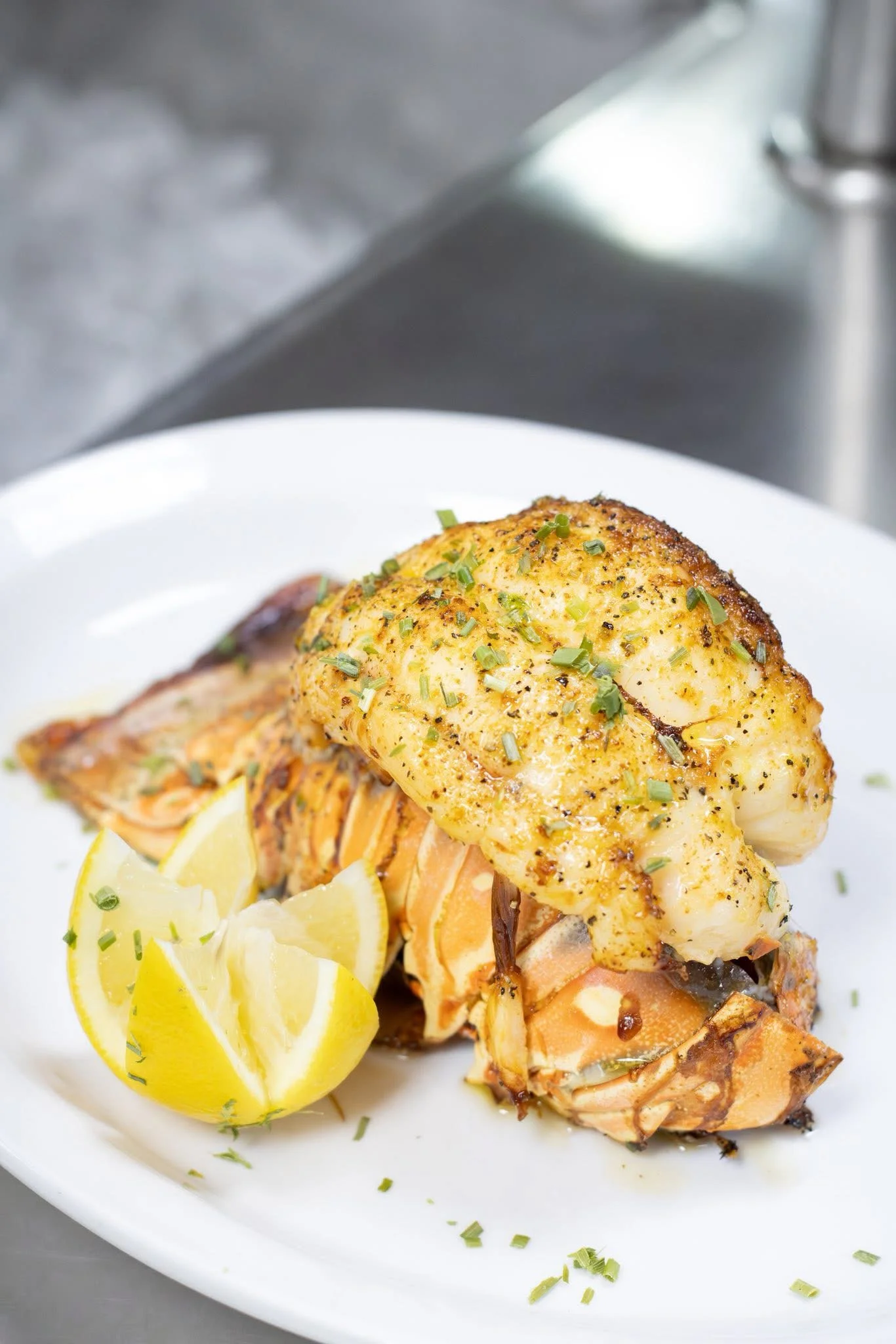 Grilled lobster tail with lemon garnish