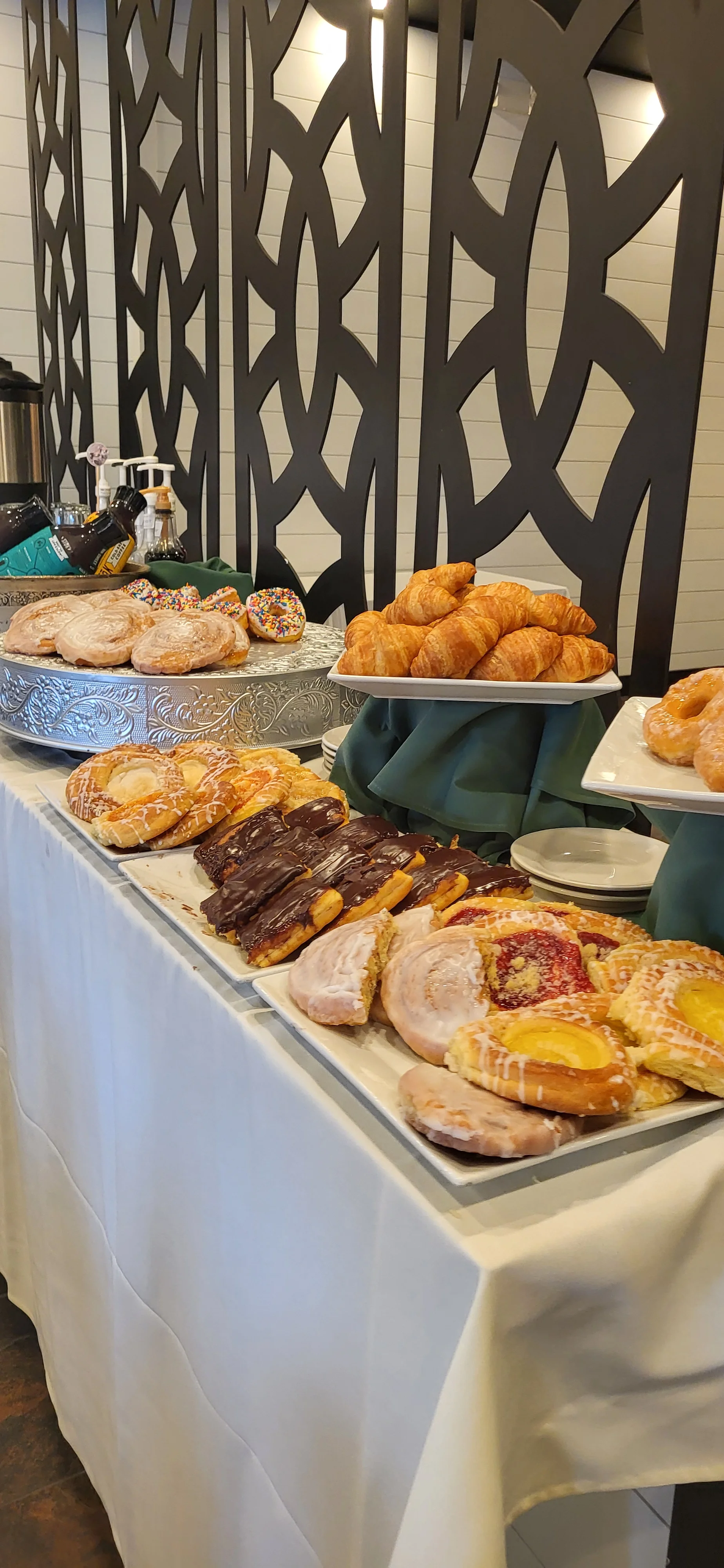 Assorted pastries including croissants and danishes on a buffet table