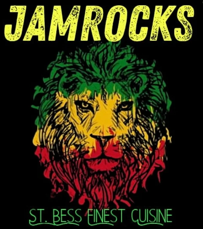 A vibrant graphic featuring a lion's face with a colorful mane in the colors of red, yellow, and green. The text above reads 'JAMROCKS' while another text below states 'ST. BESS FINEST CUISINE'.