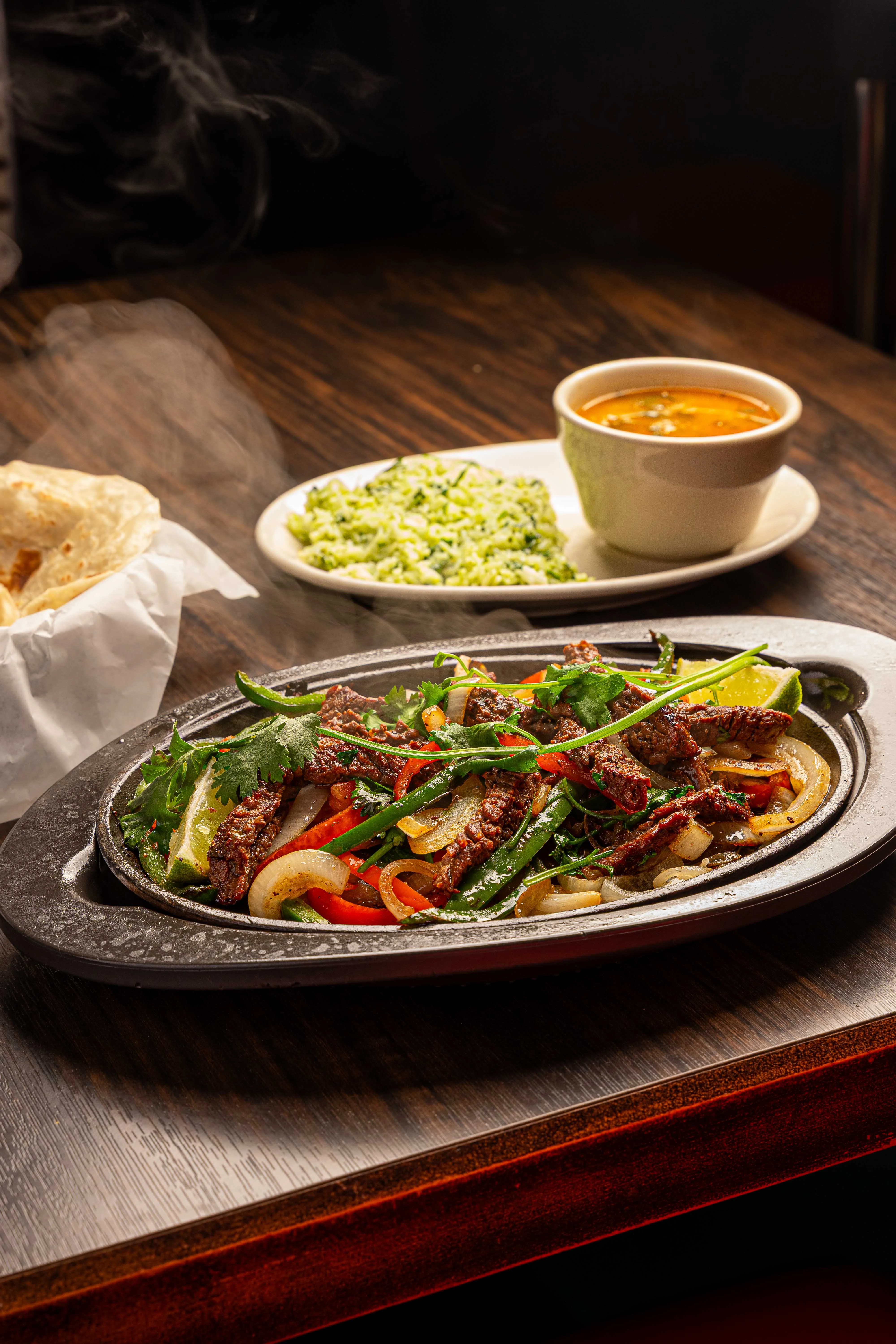 Sizzling fajitas served with rice and soup
