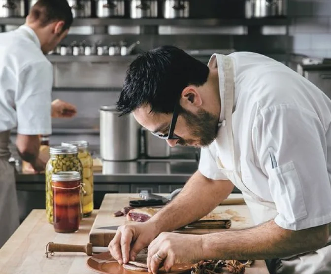 A restaurant chef preparing a dish