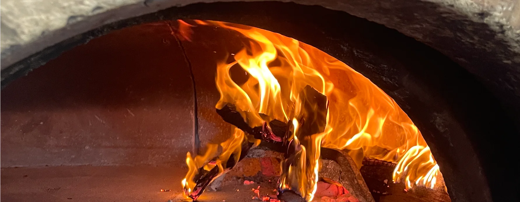 Flames dancing in a traditional wood-fired oven