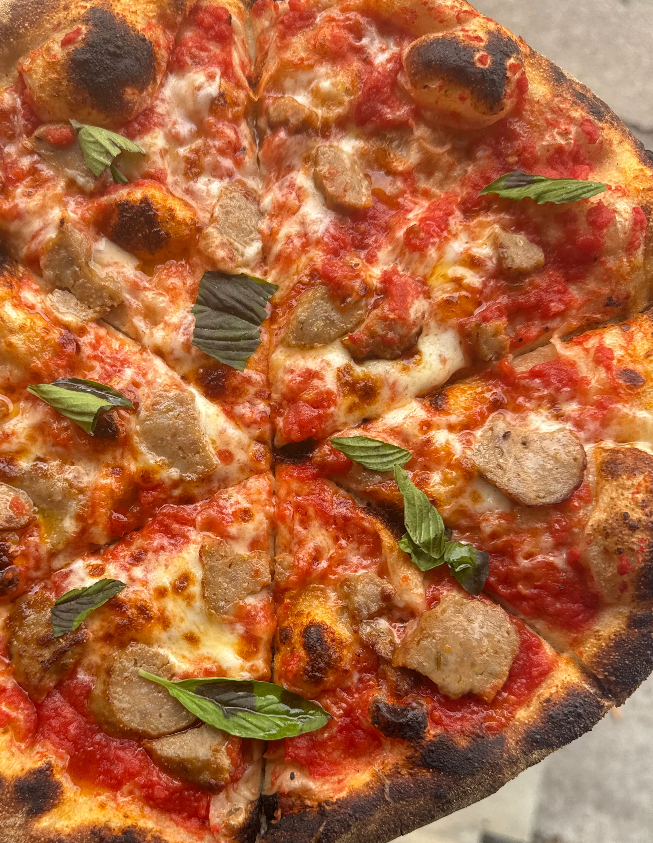 Close-up of Neapolitan-style pizza with a blistered charred crust