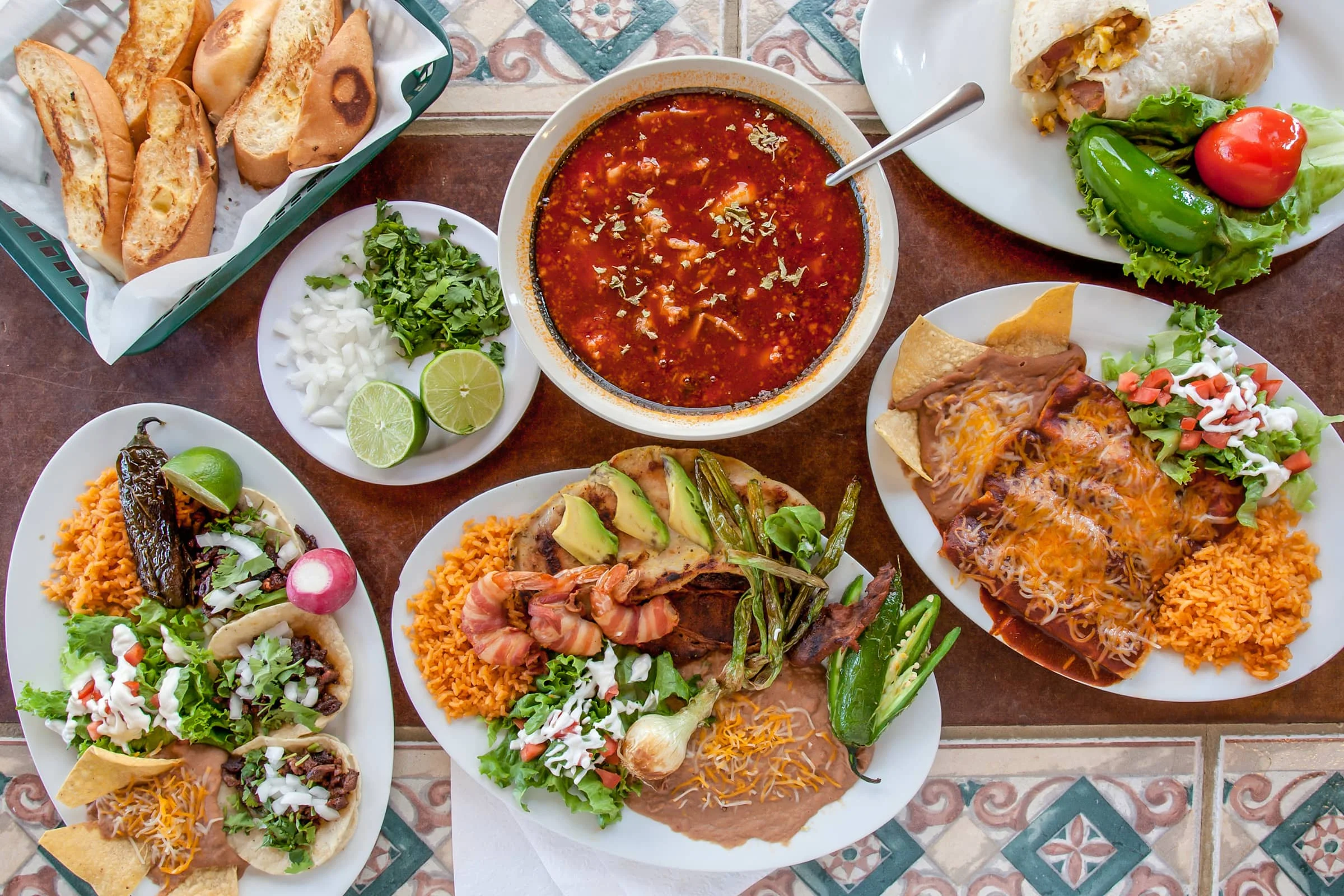 Colorful Mexican feast with tacos, enchiladas, and soup