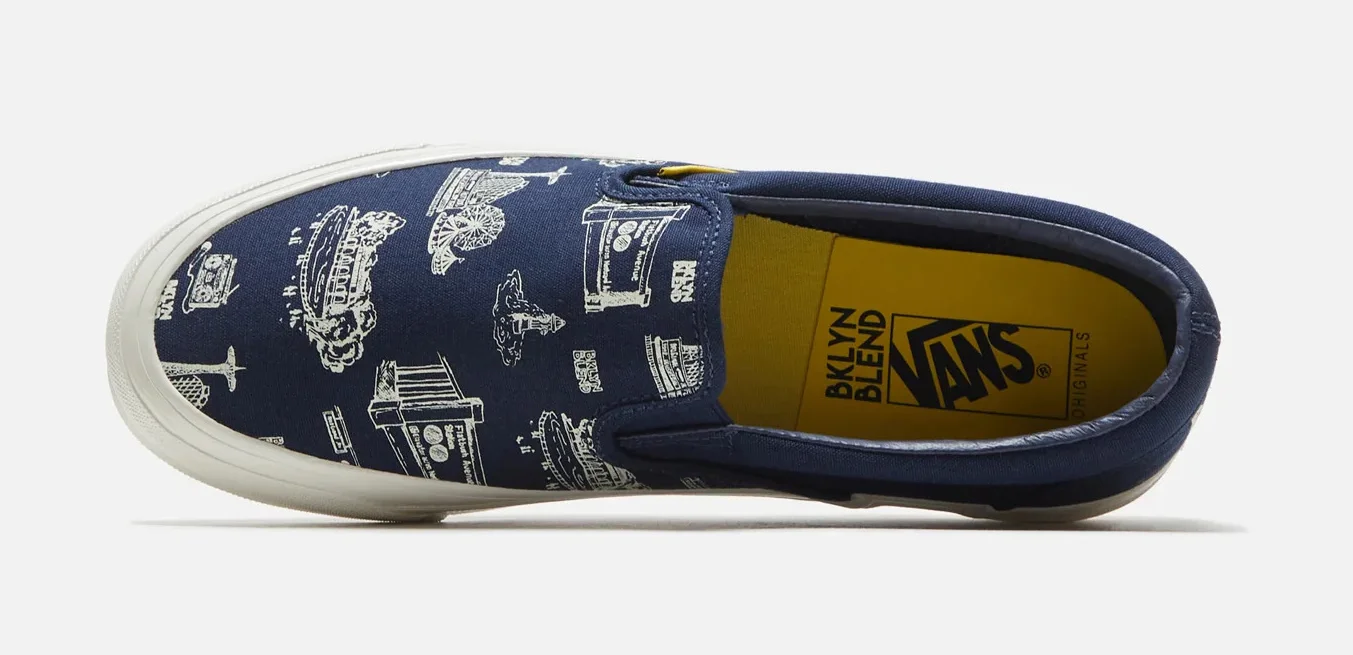 Navy blue Vans slip on shoe with yellow shoe inserts that have the Vans and BKLN BLEND logo on them, pattern white line illustrations depicting various places in Brooklyn, NY and the BKLYN BLEND locations