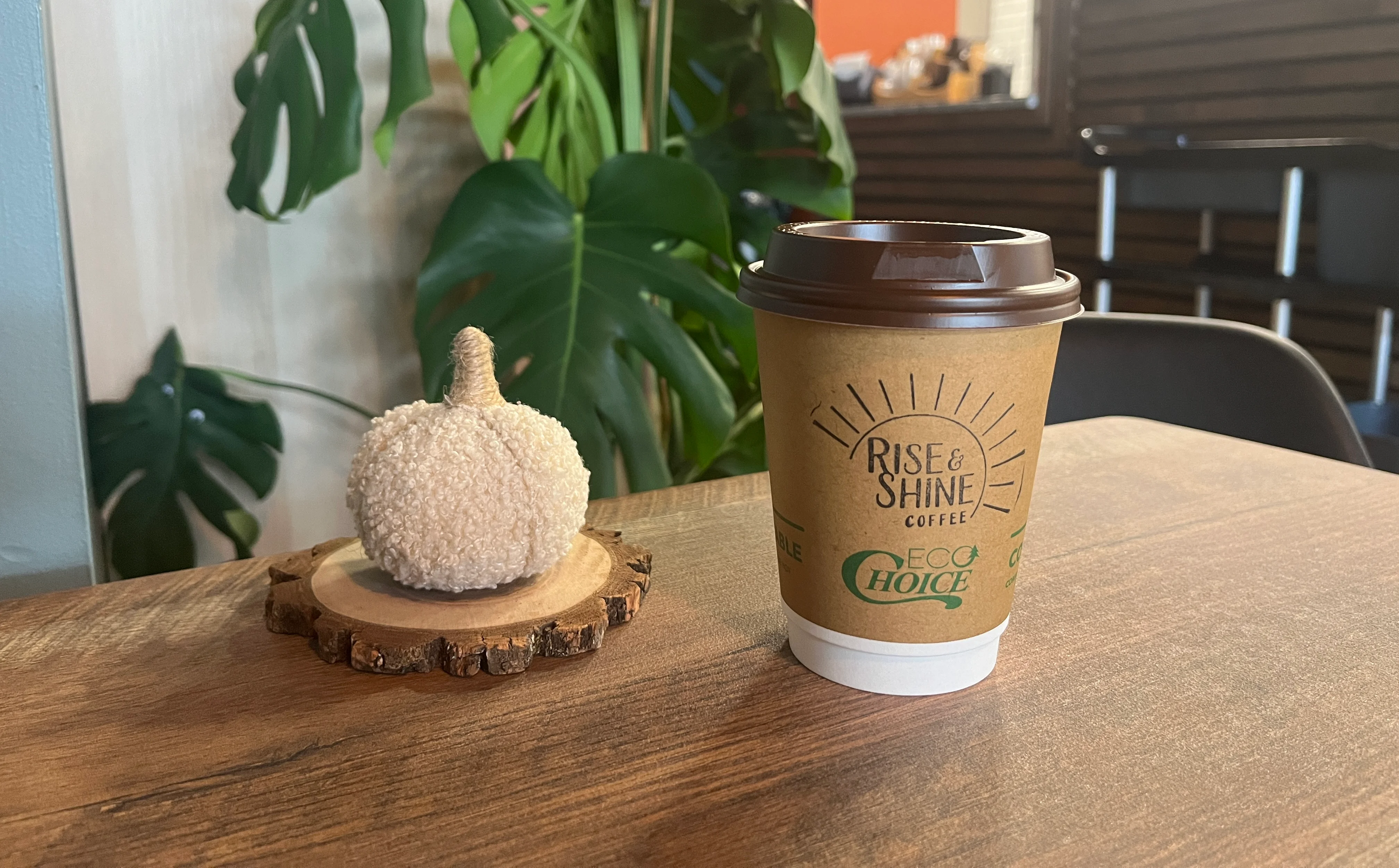 Coffee cup on a wooden table in a cozy café setting
