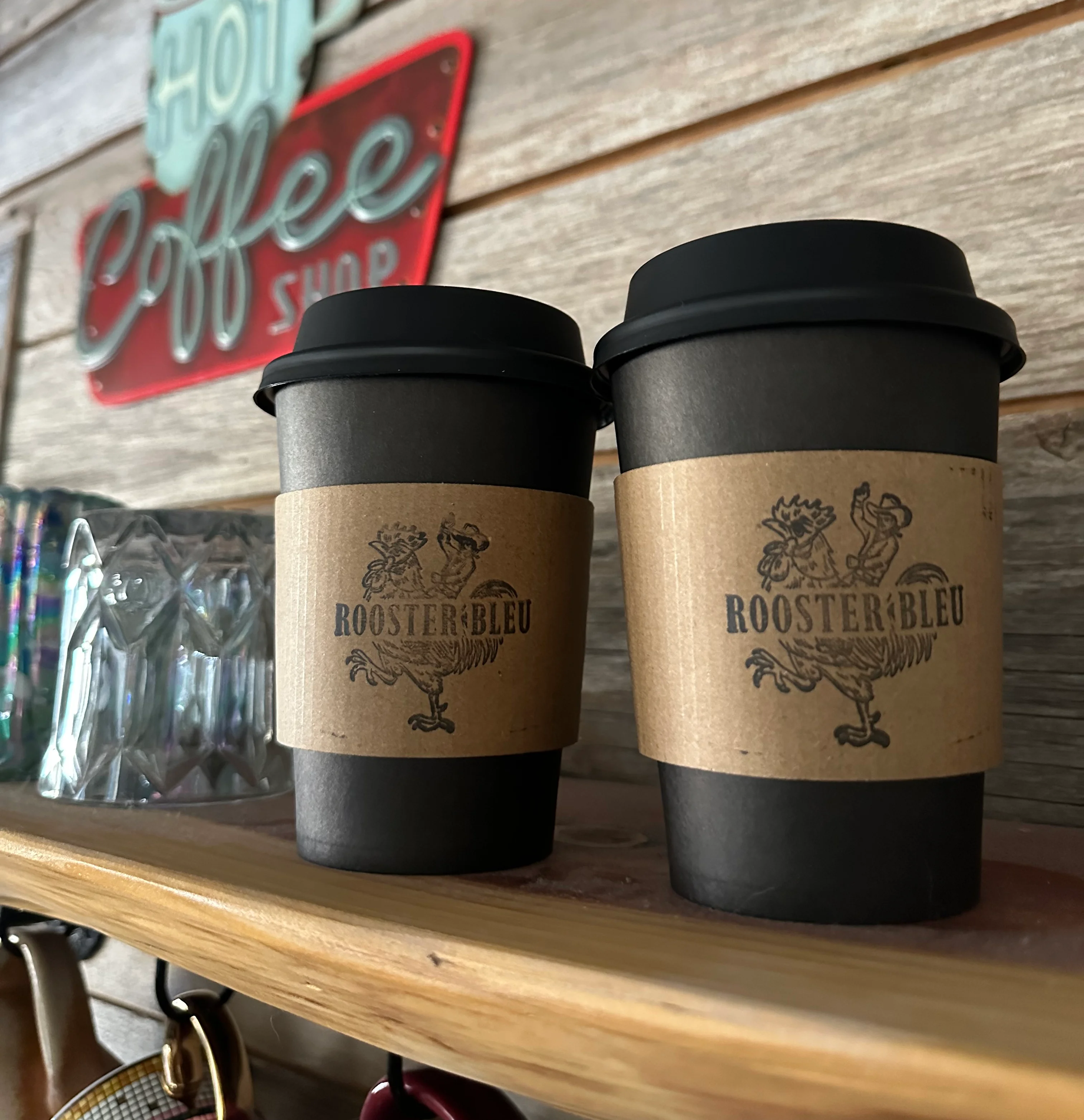 Coffee cups from Rooster Bleu in a cozy café setting