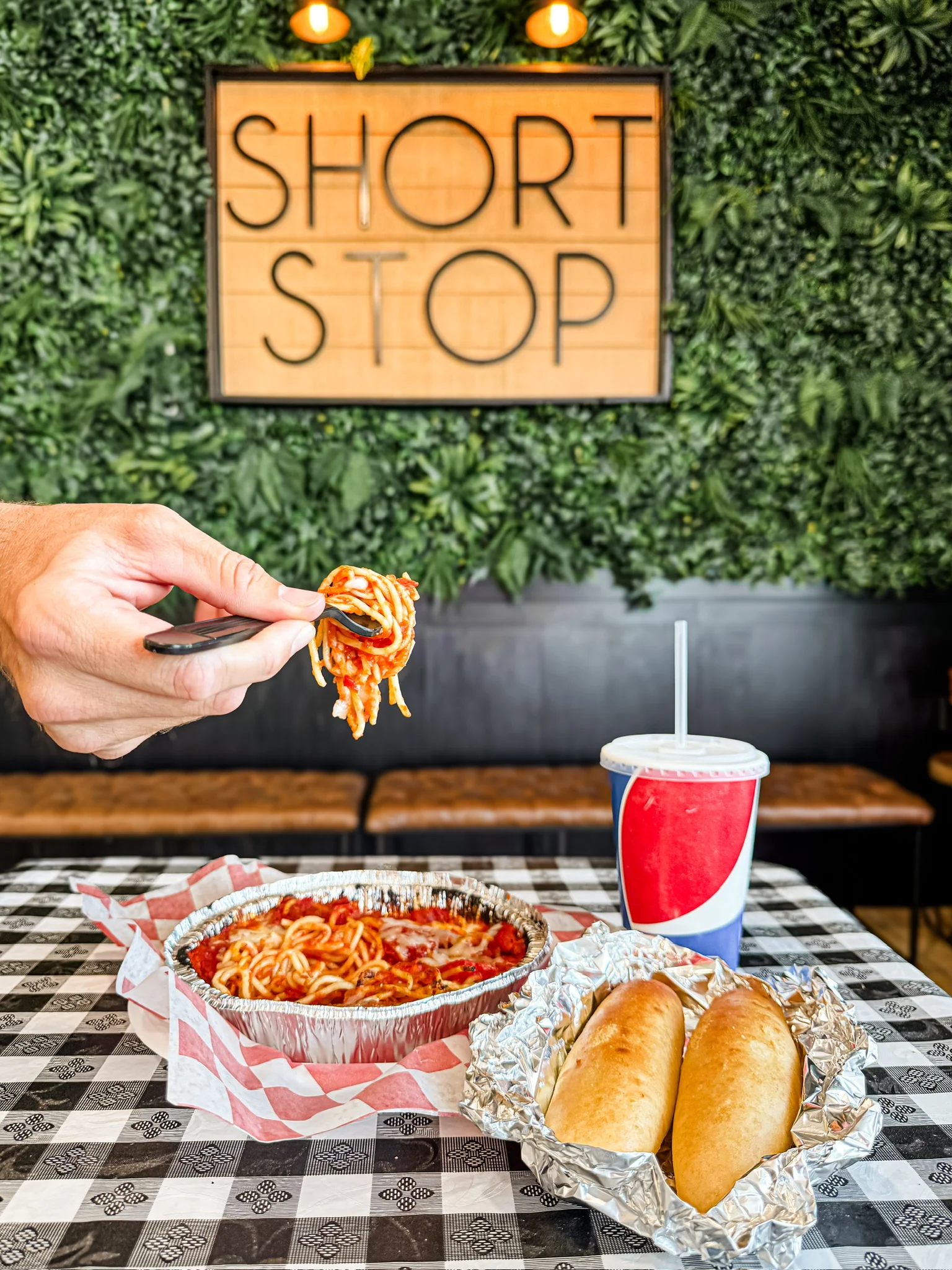 Plate of spaghetti with marinara sauce in a casual dining setting
