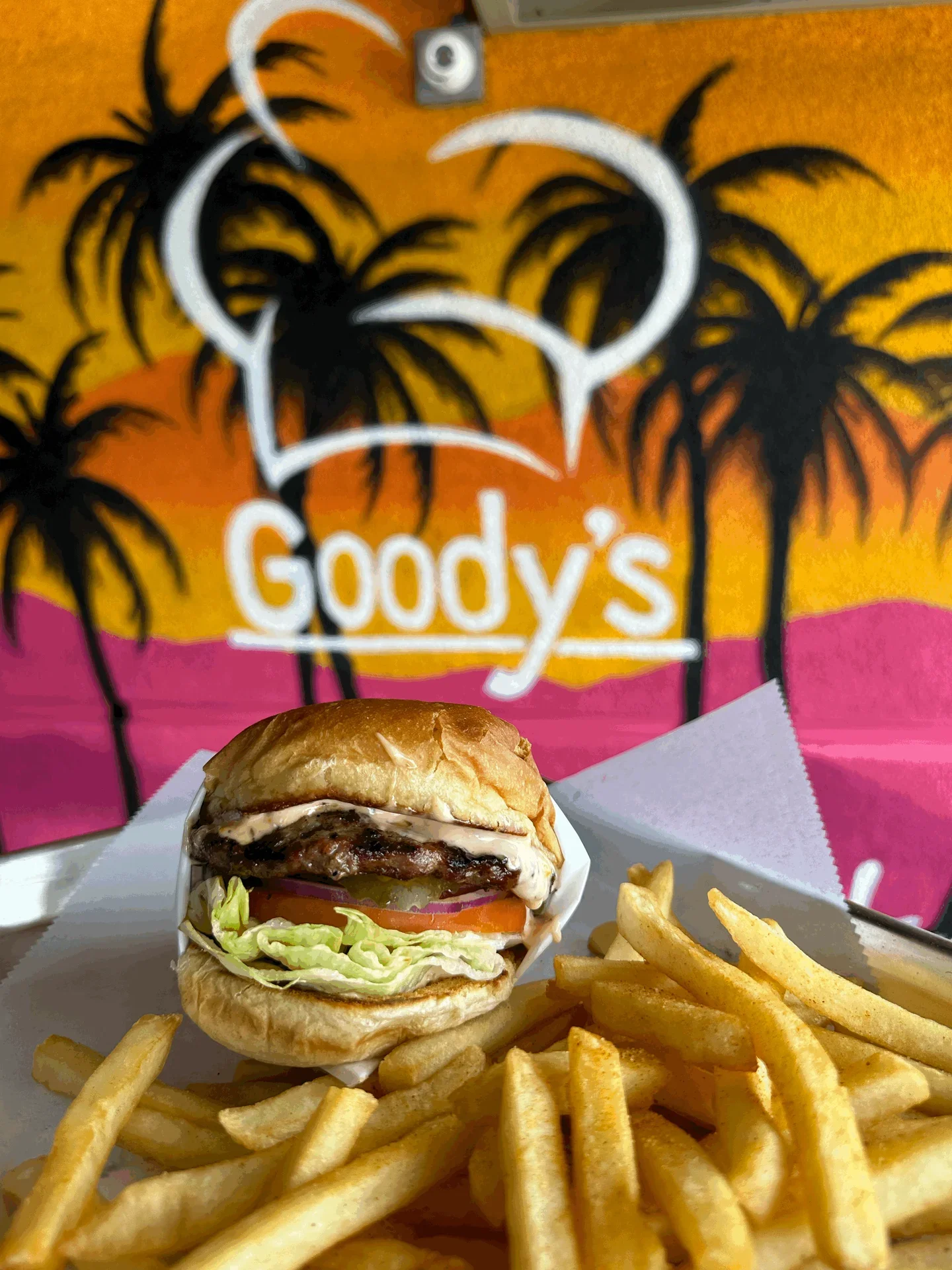 Juicy cheeseburger with fries at a vibrant beachside eatery