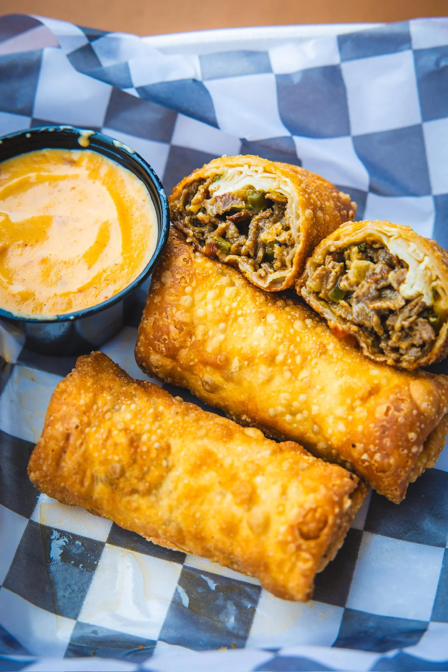 Philly cheesesteak eggrolls with queso dipping sauce