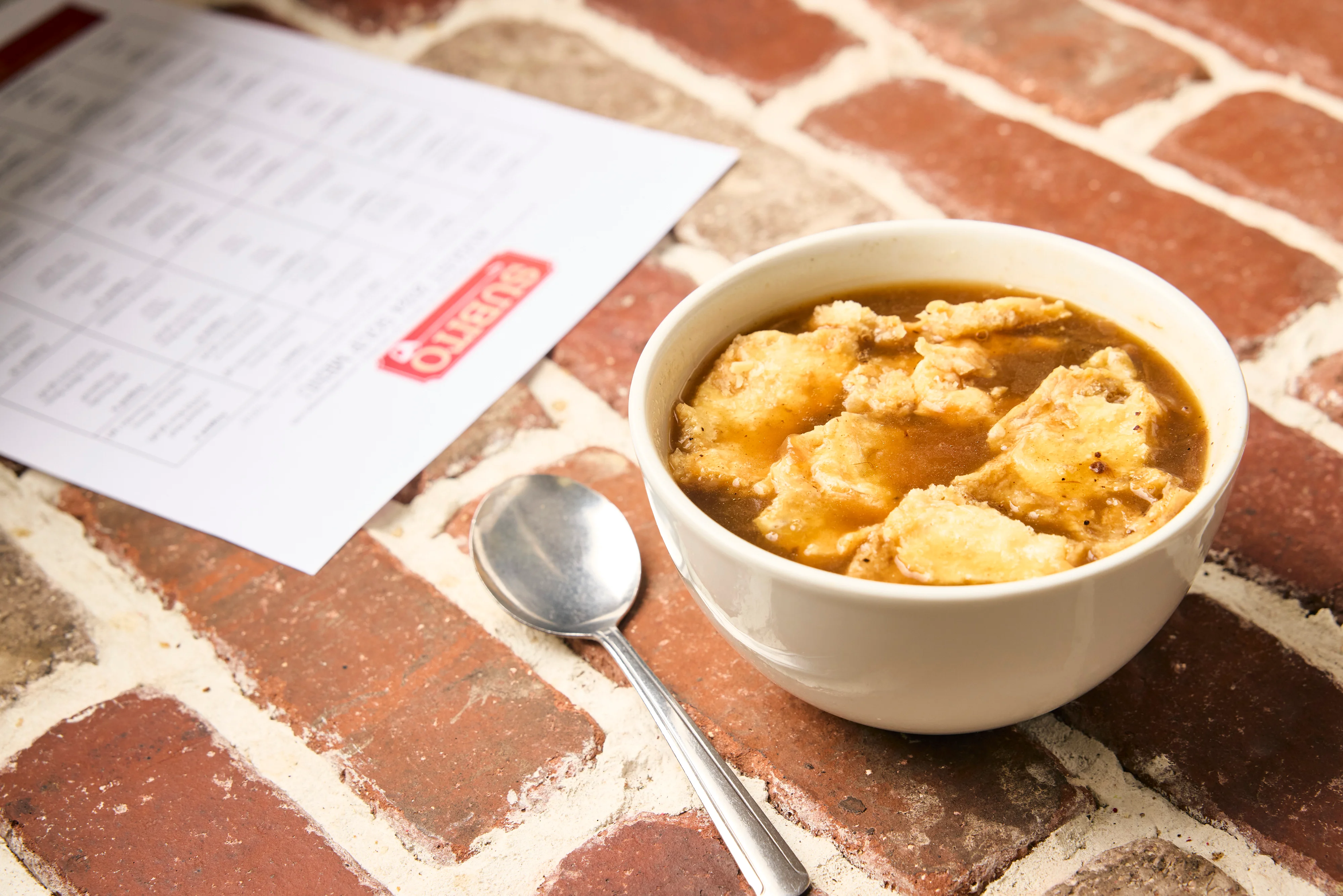 Pork Chile Verde has pork shoulder braised in housemade salsa verde then simmered with onion, white hominy, and fresh cilantro in a spicy broth.