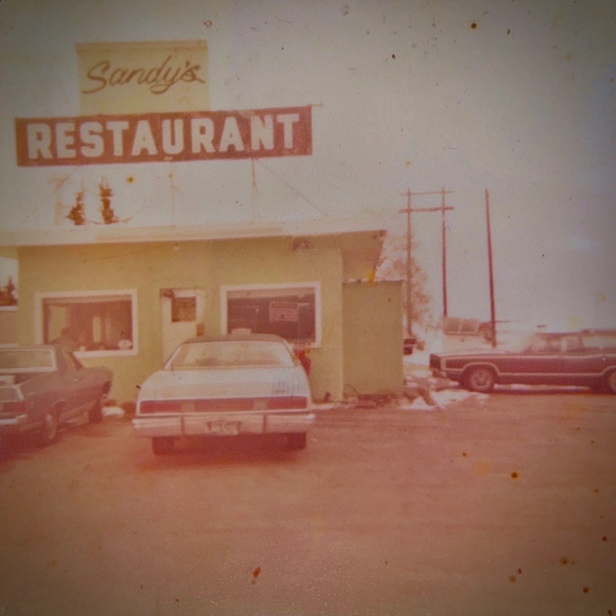 Vintage restaurant exterior with classic cars