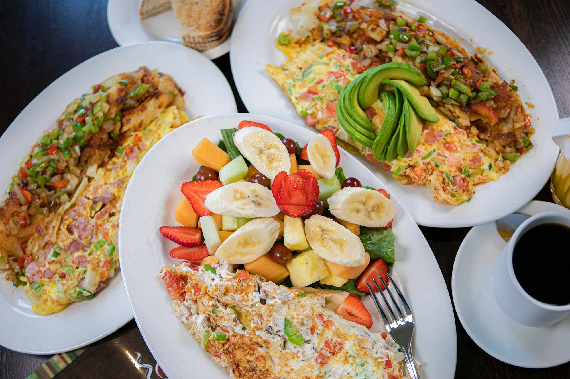 Hearty American breakfast with omelets and fresh fruit salad
