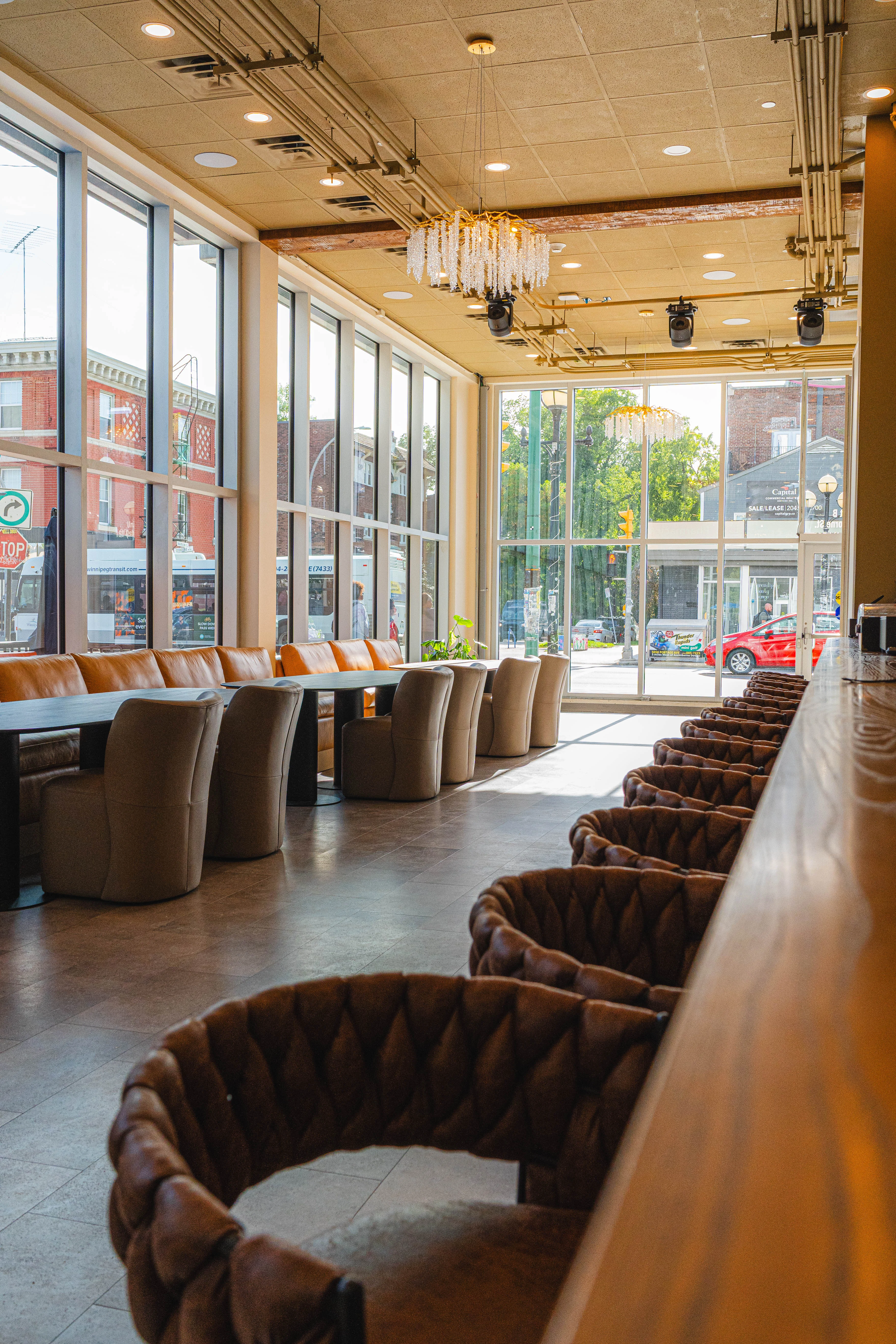 Modern restaurant interior with large windows and stylish seating