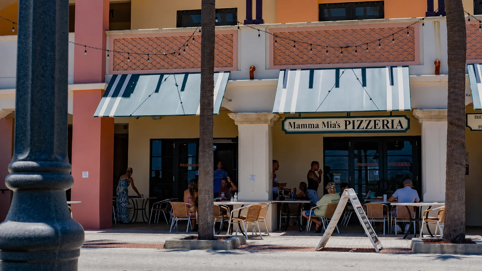 Outdoor dining at Mamma Mia's Pizzeria with patrons enjoying the ambiance