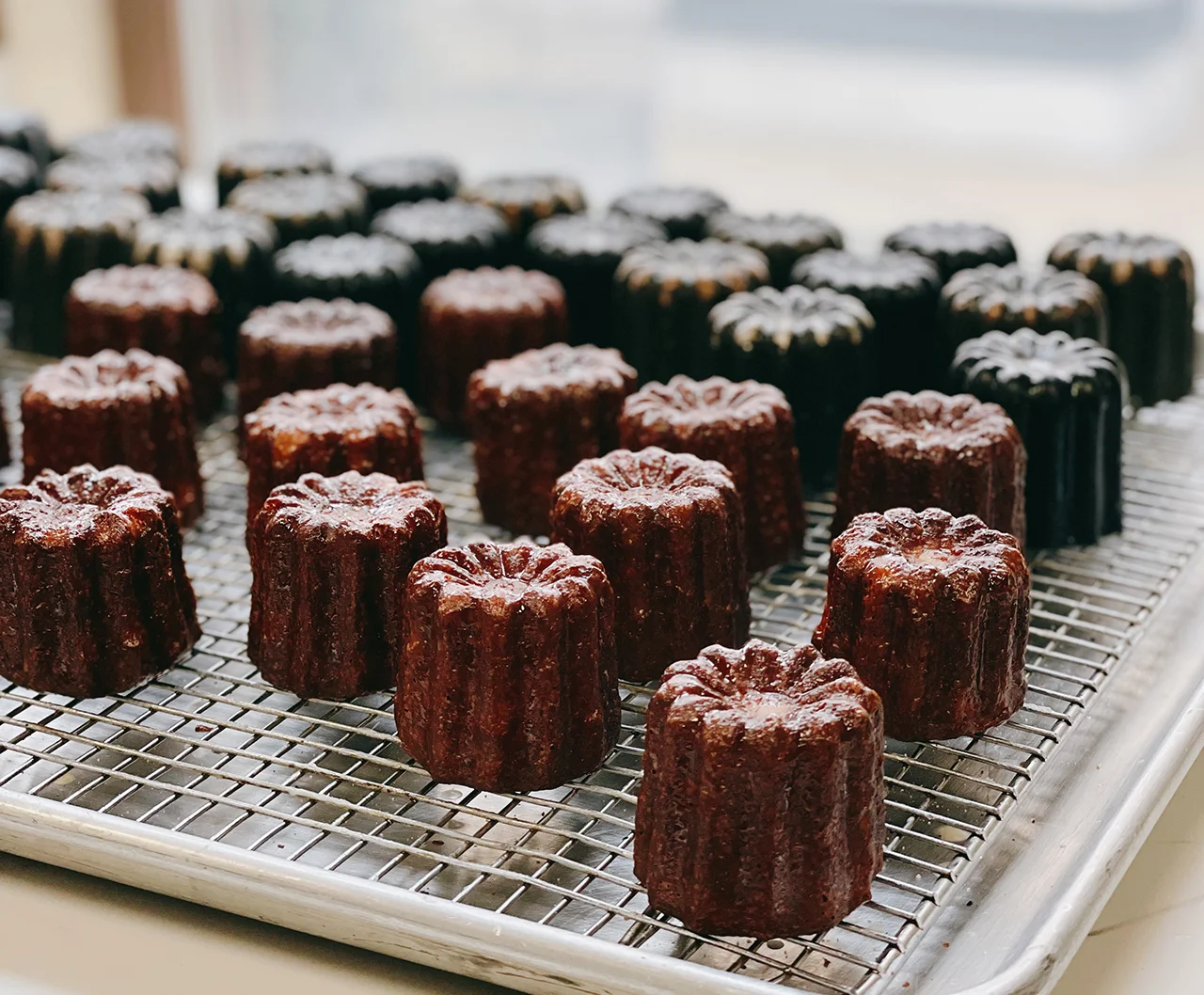 Golden canelés just out of the oven, baked in Chicago with authentic French know-how