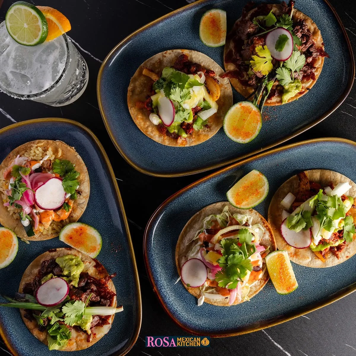 Mexican street tacos with cilantro, radish, guacamole, and lime