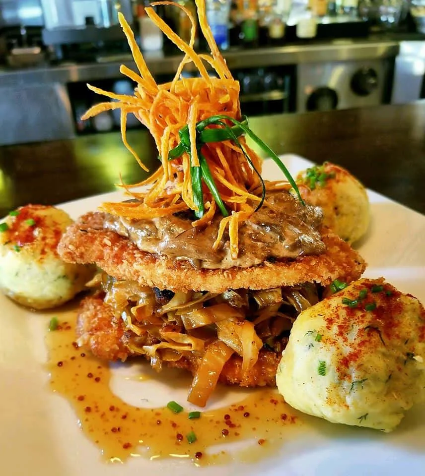 Crispy fried chicken with savory sauce and vegetables