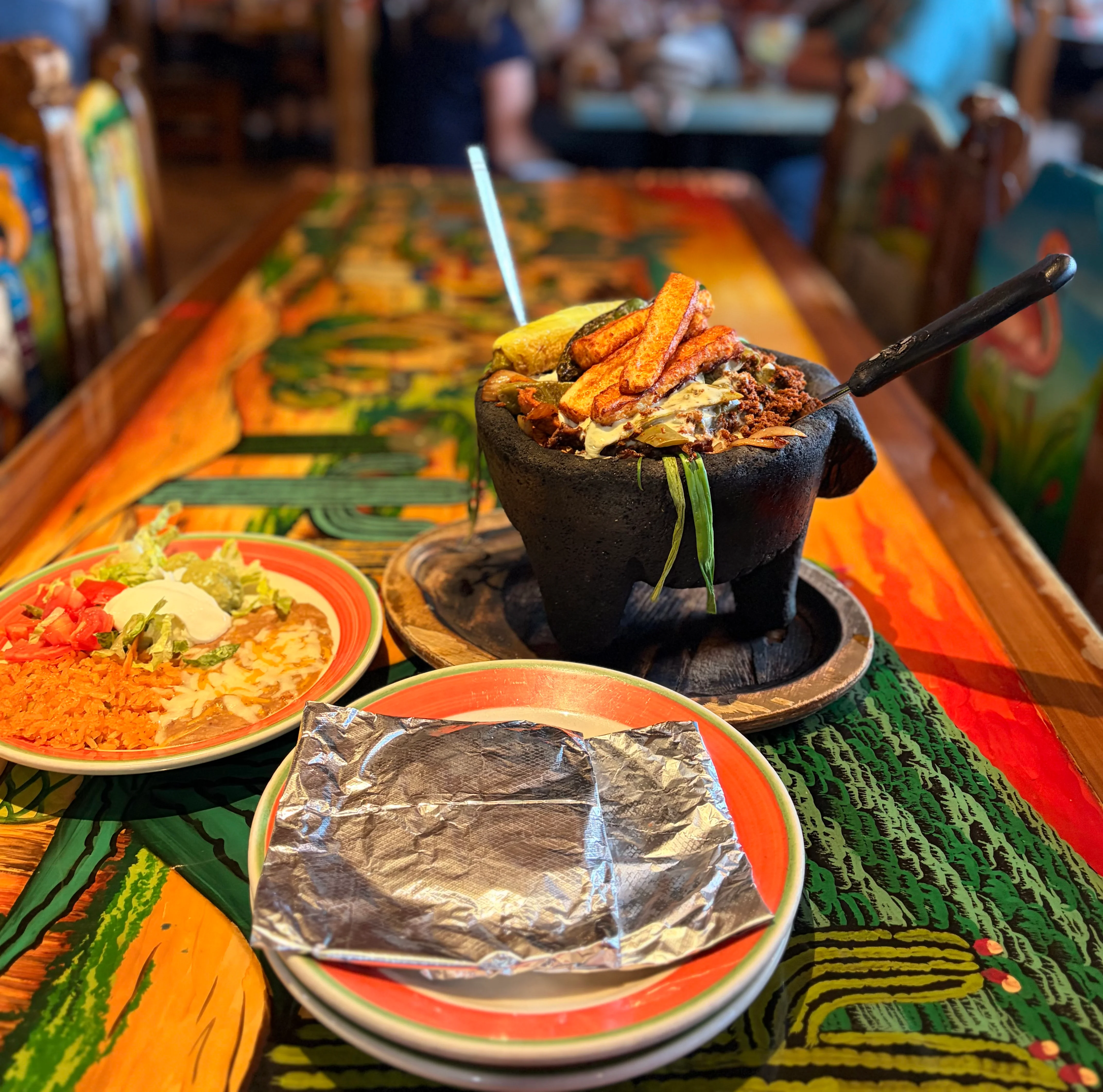 Delicious gourmet burger with fresh toppings on a wooden table.