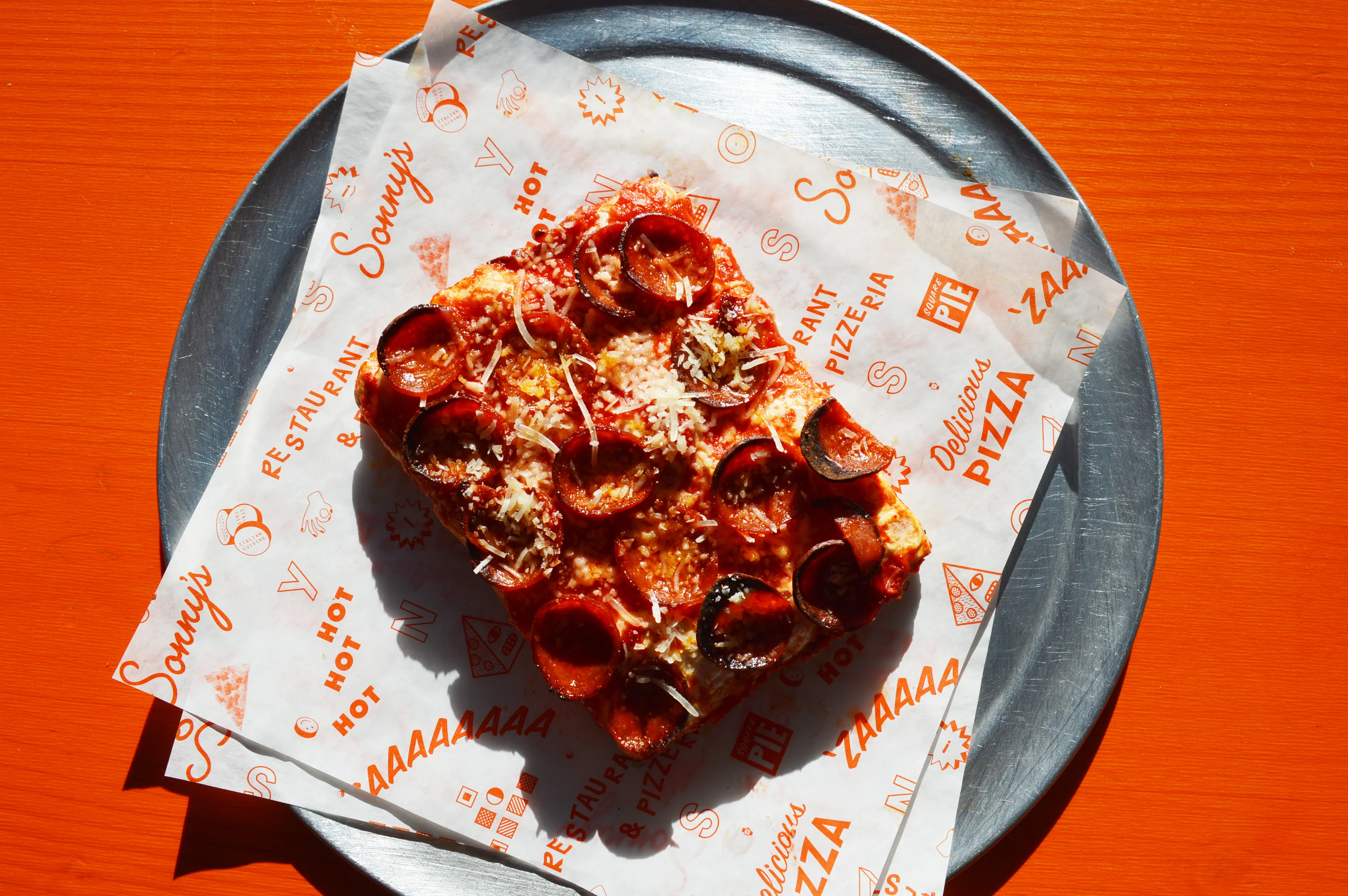 Pepperoni pizza slice on parchment paper