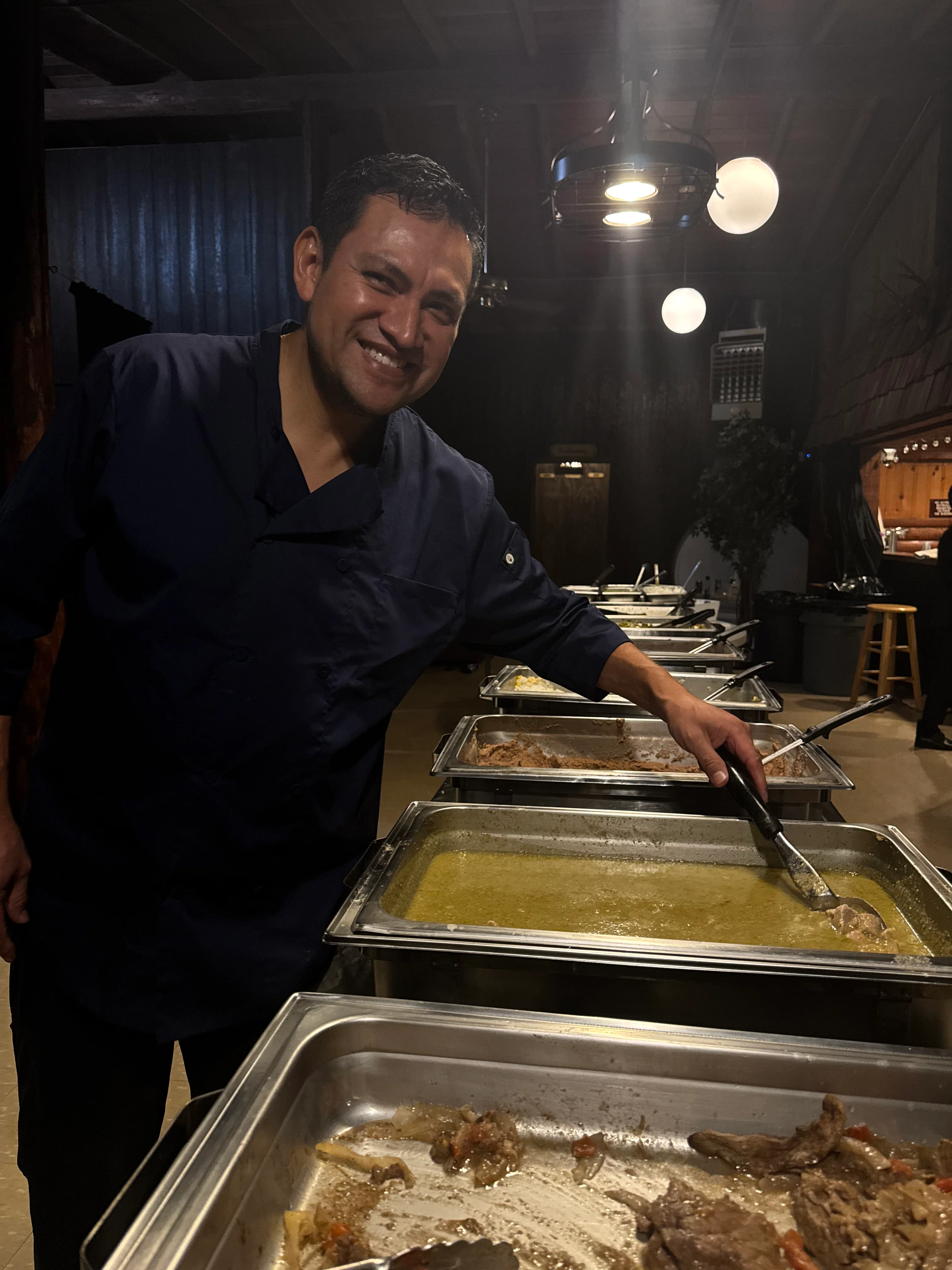 Chef serving traditional Mexican dishes at a buffet