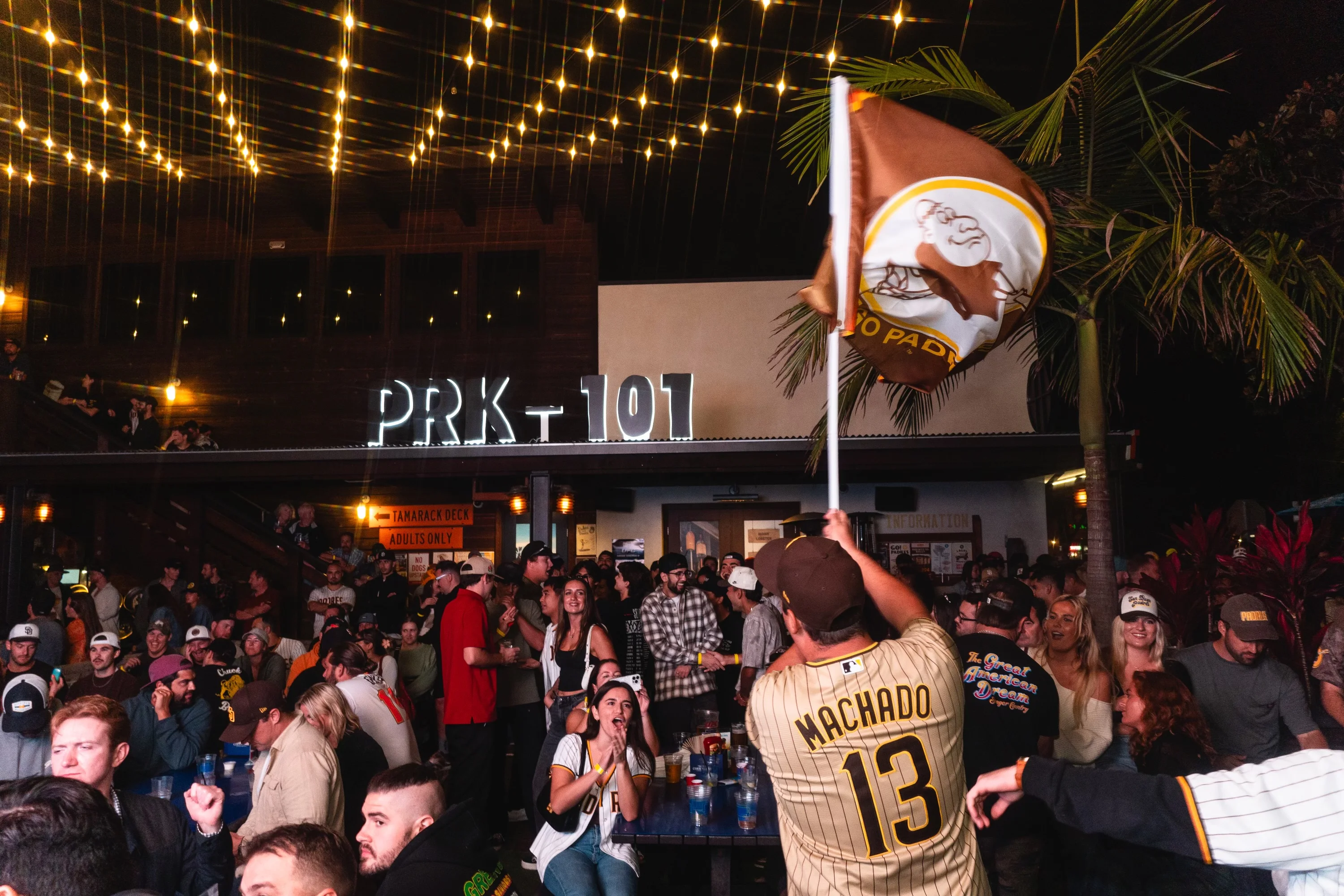 Crowd enjoying a lively atmosphere at PRK 101 with festive lights.