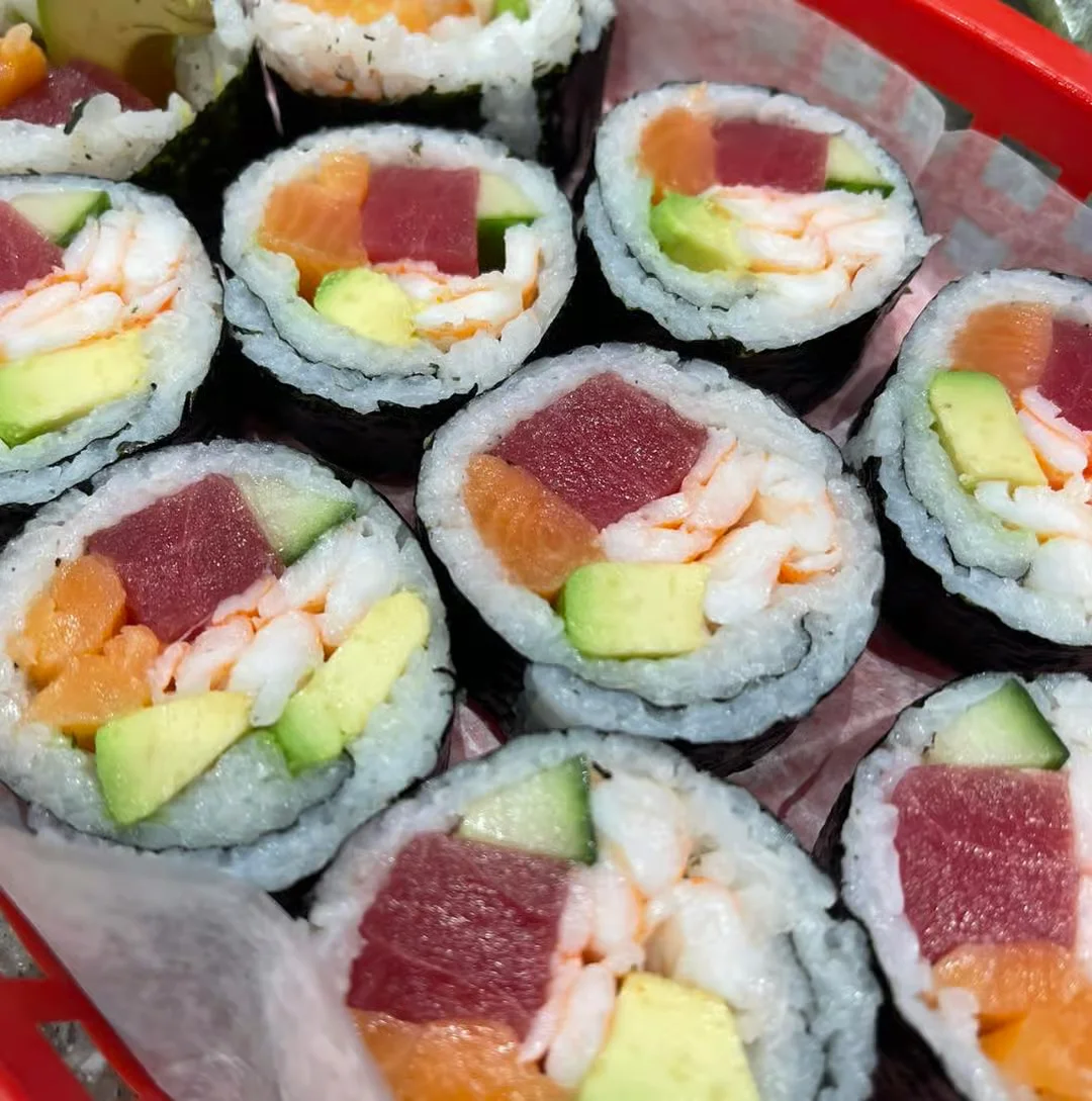 Japanese sushi rolls with a colorful fusion rice bowl