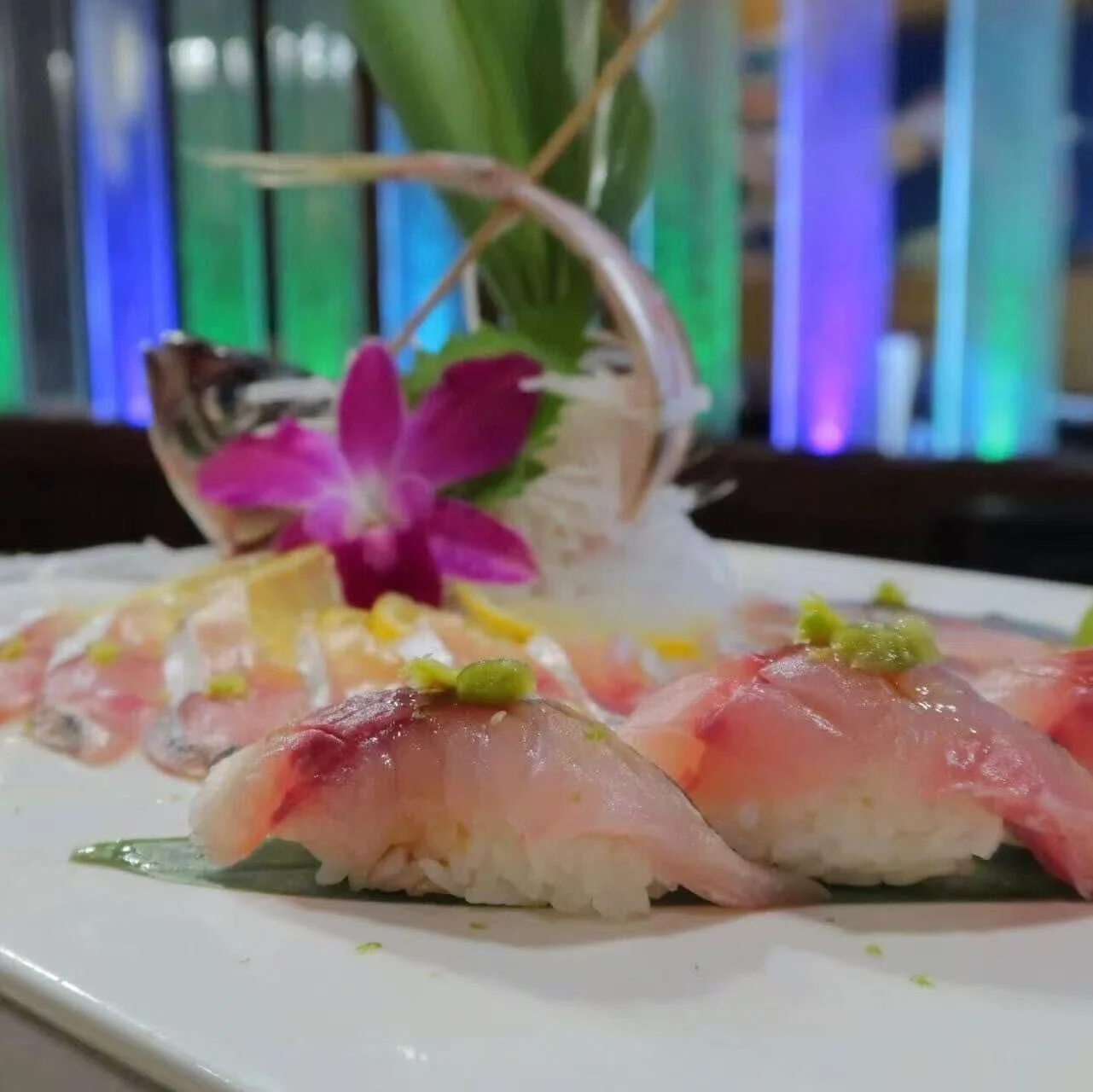 Artfully arranged sushi platter with fresh fish and garnishes