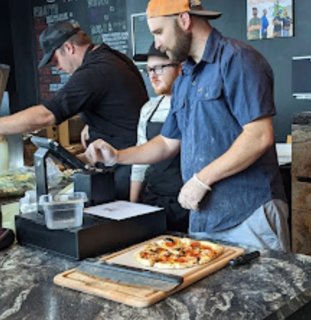 Pizza being prepared in a modern pizzeria kitchen