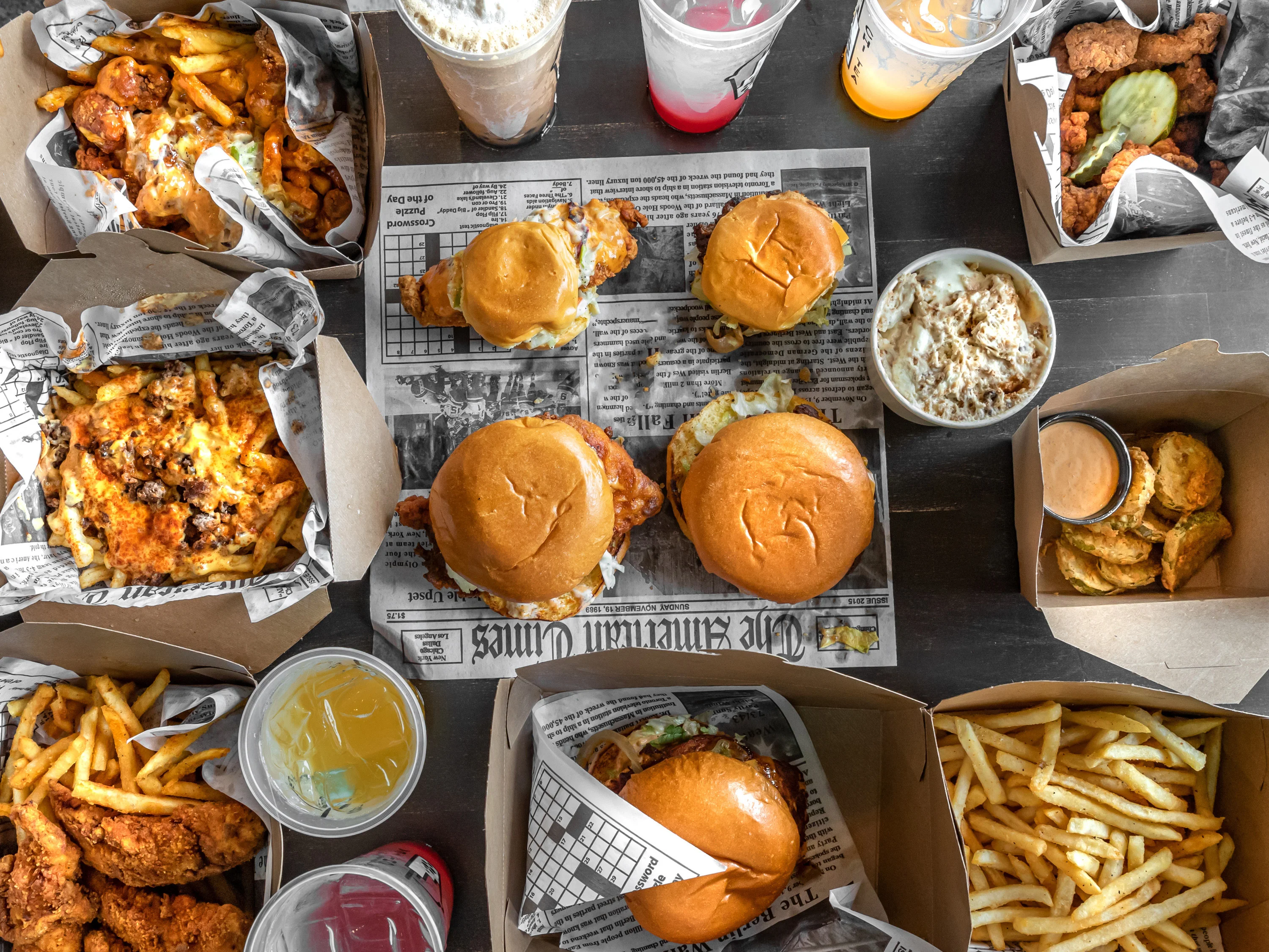 Assorted American comfort food with burgers, fries, and fried chicken