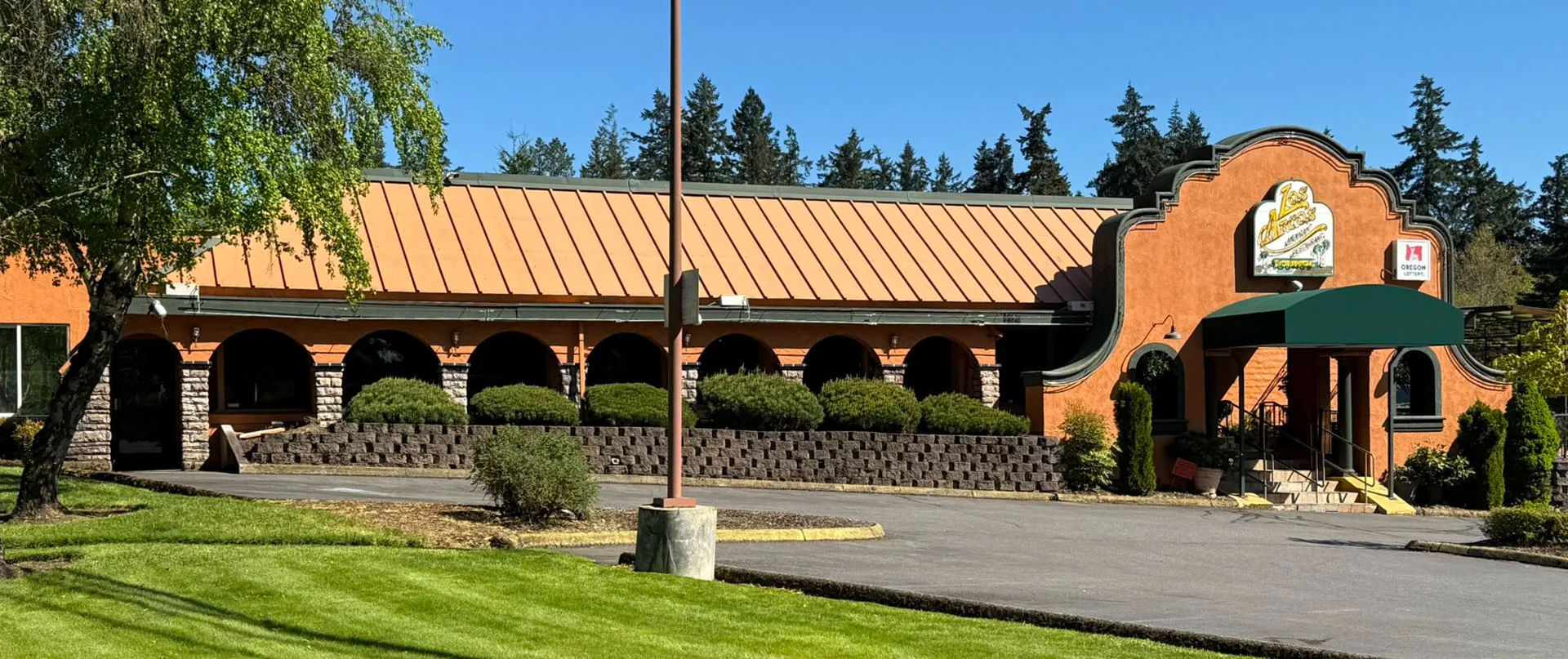 Exterior view of Los Arcos Mexican Grill with vibrant signage.