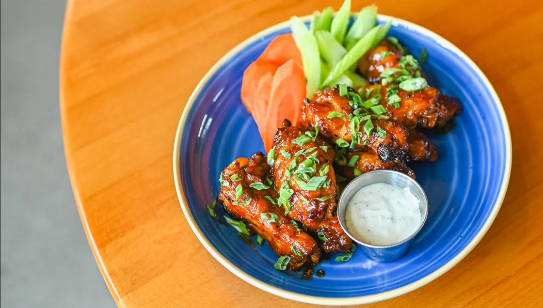 Crispy buffalo chicken wings served with celery and ranch dressing