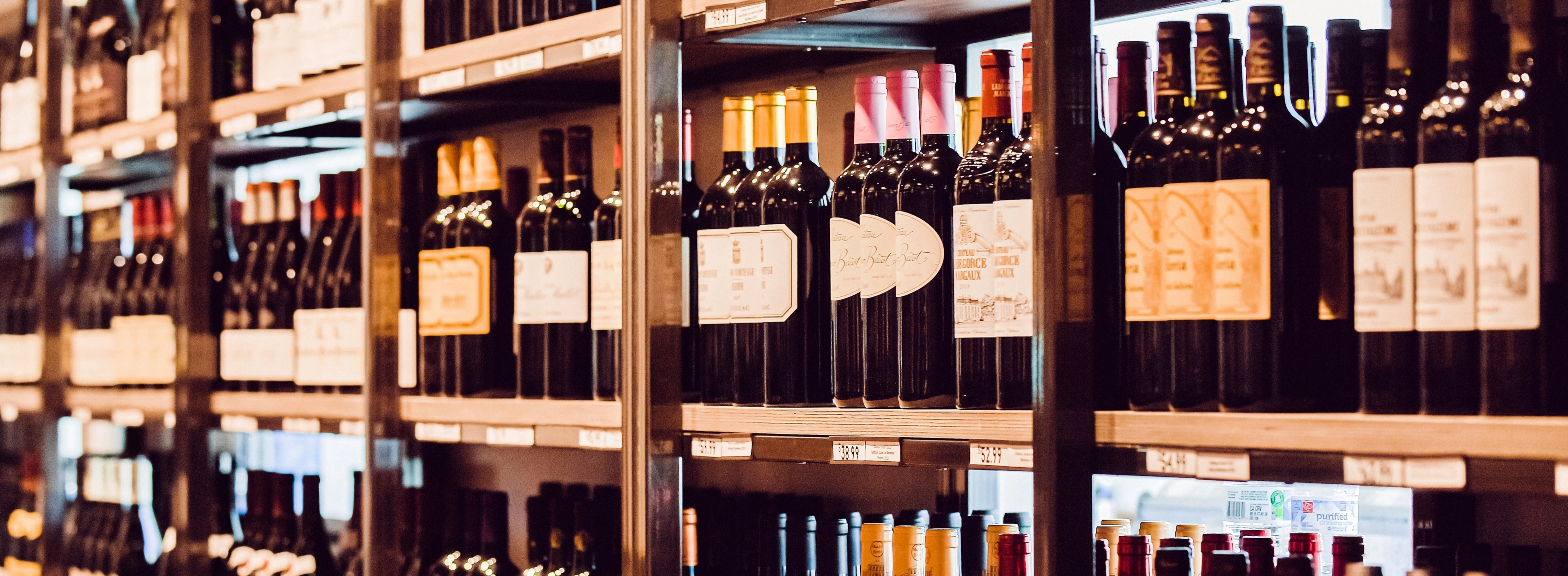 Wine bottles neatly arranged on shelves in a retail store