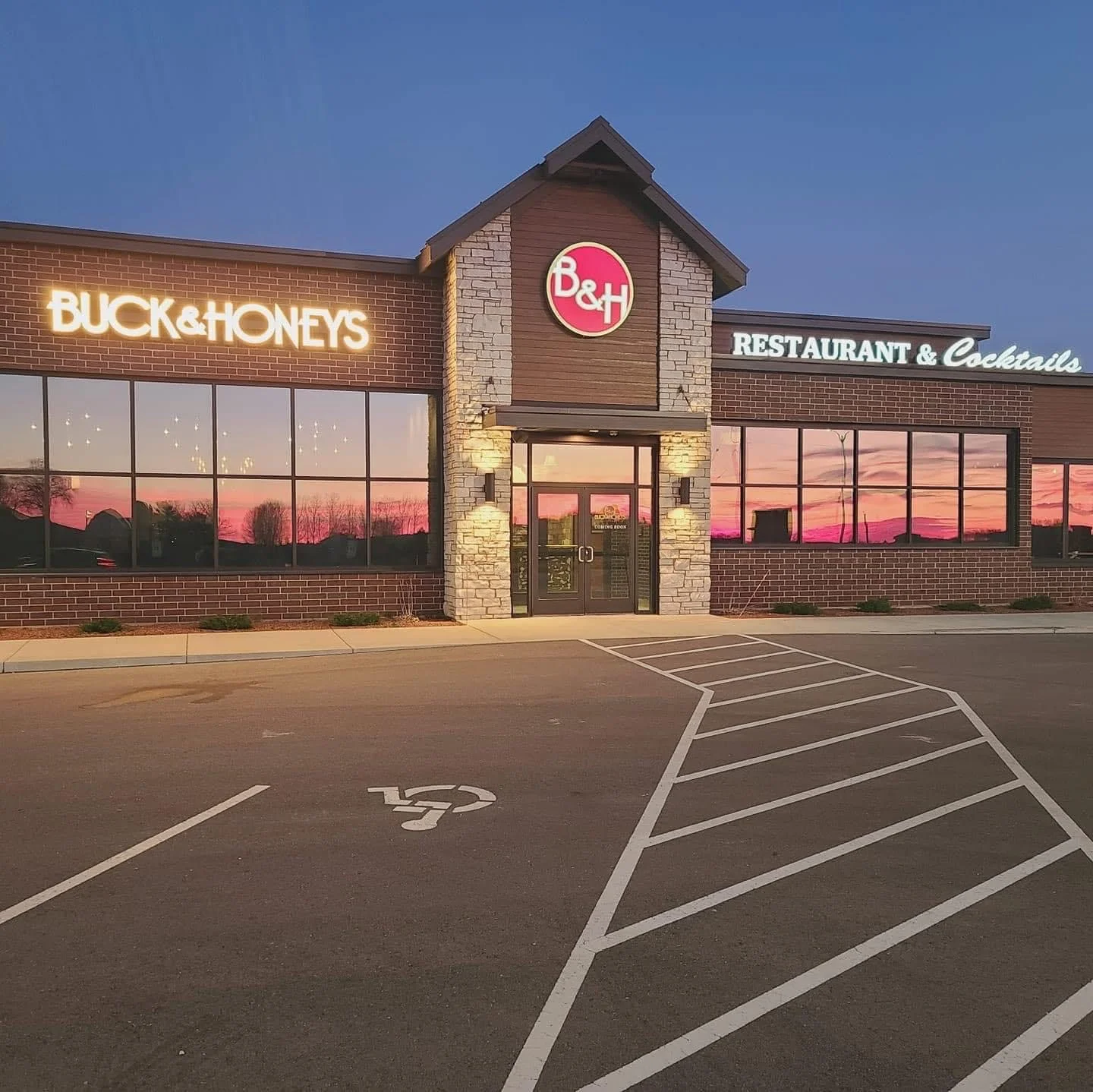 Modern restaurant exterior with warm lighting at sunset