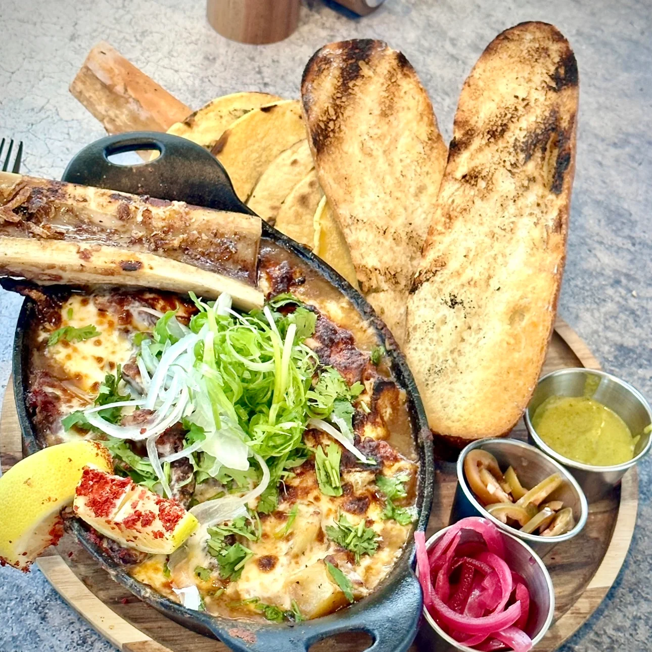 Sizzling Mexican queso fundido with tortillas and toppings