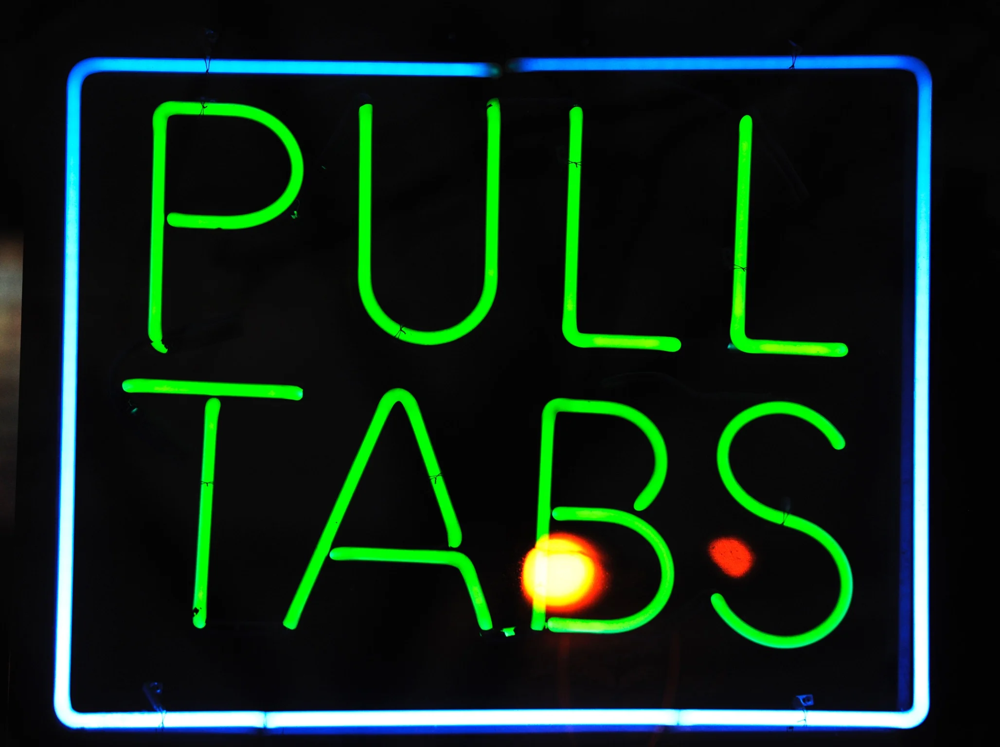 Neon sign displaying 'Pull Tabs' in vibrant colors