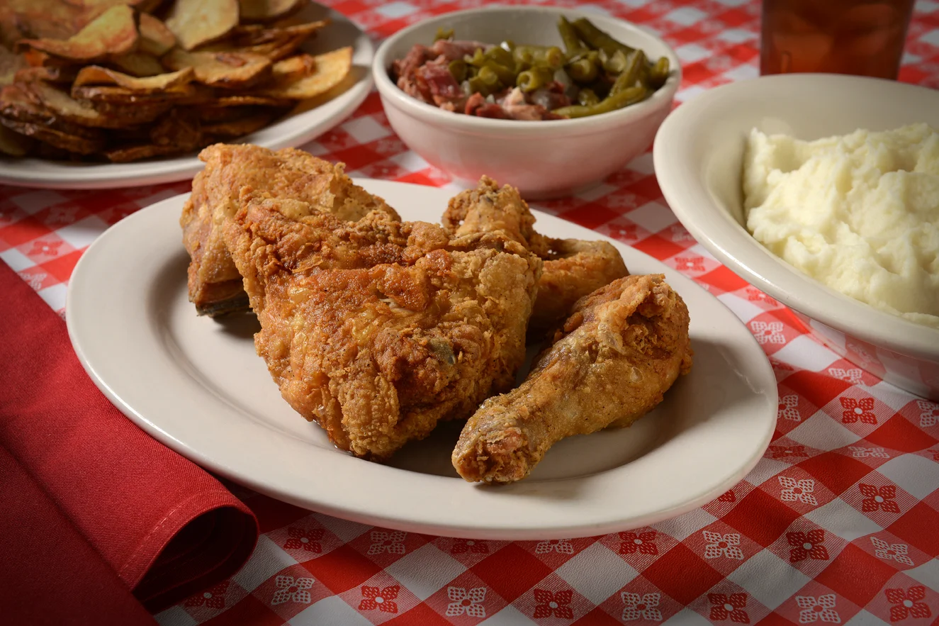 Southern fried chicken with sides on a checkered tablecloth