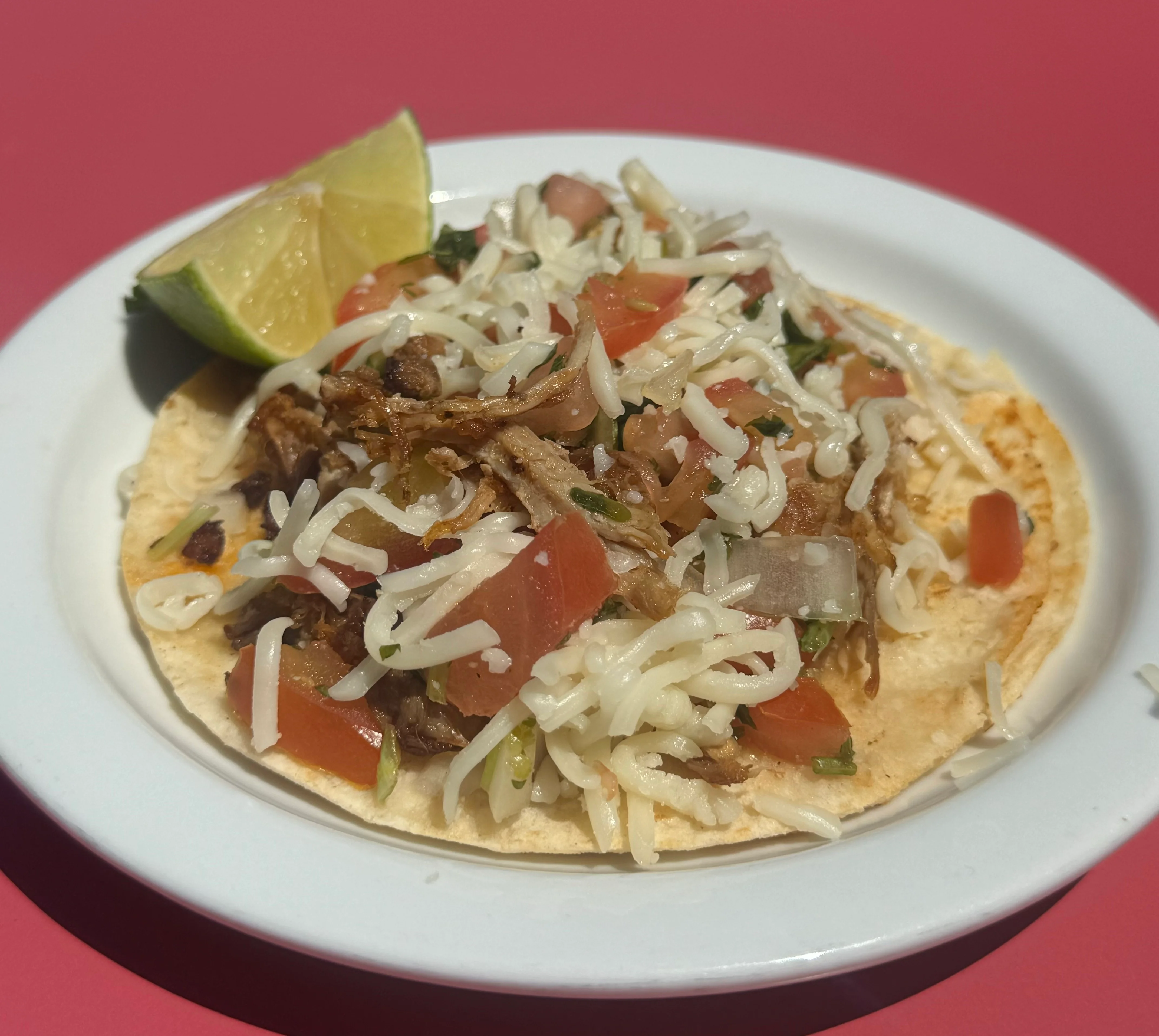 Delicious Mexican street taco with shredded meat and fresh toppings