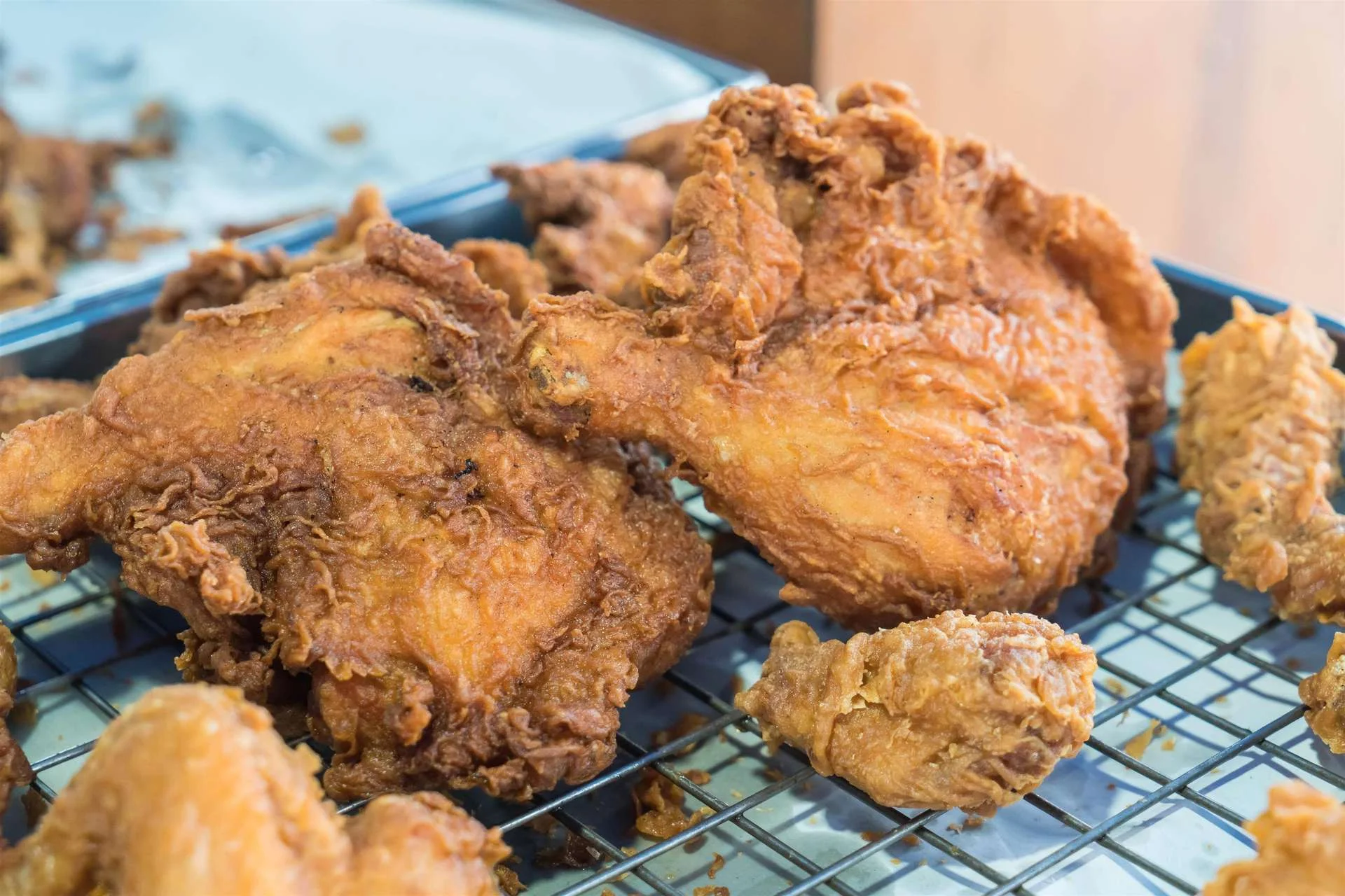 Crispy Southern fried chicken pieces on a cooling rack