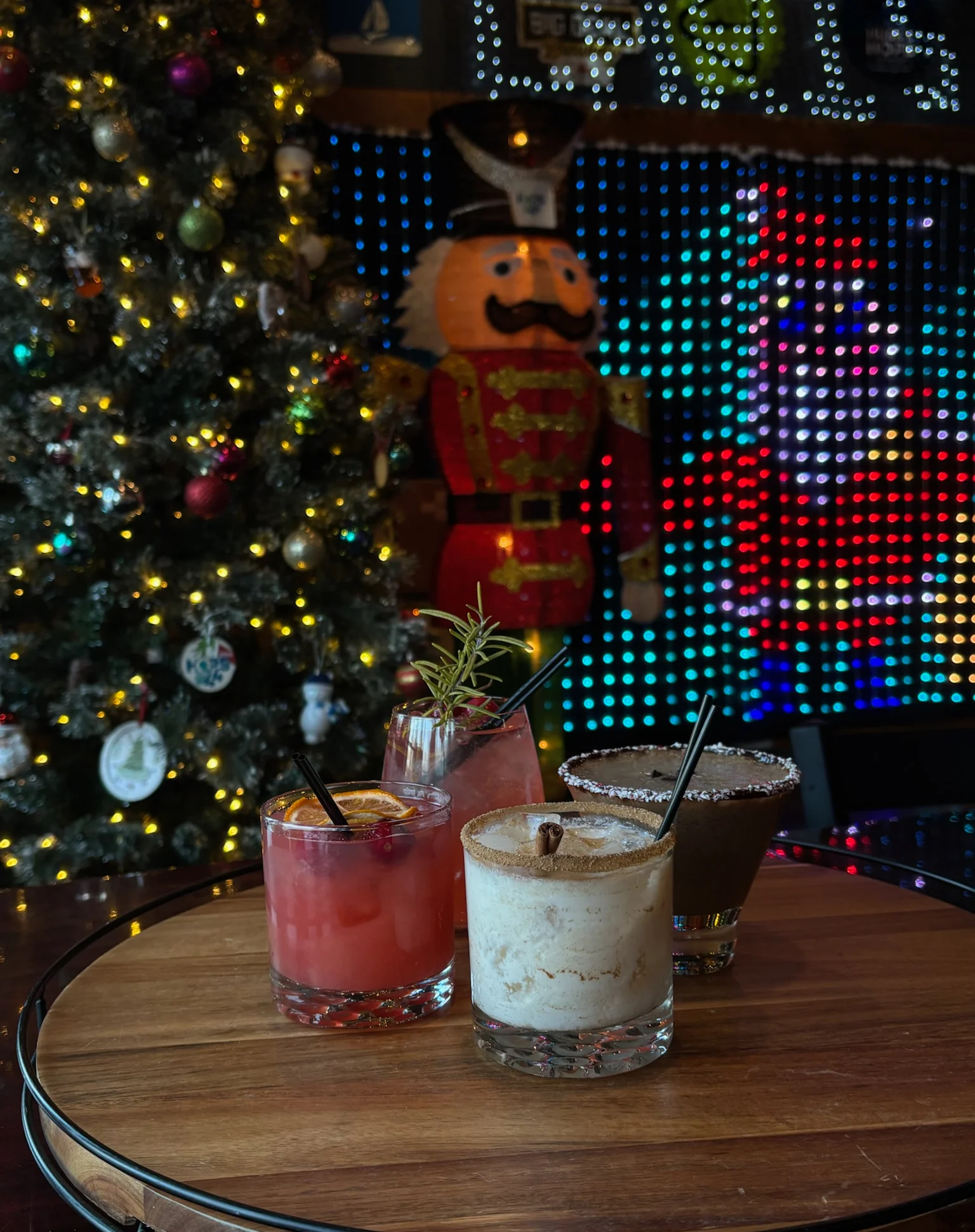 Festive cocktails on a wooden tray with holiday decor