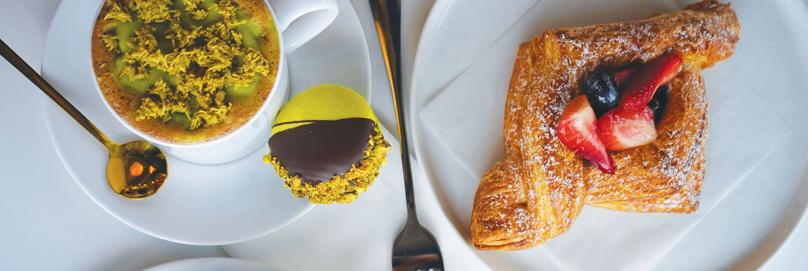 Artisan pastries including croissant and matcha dessert