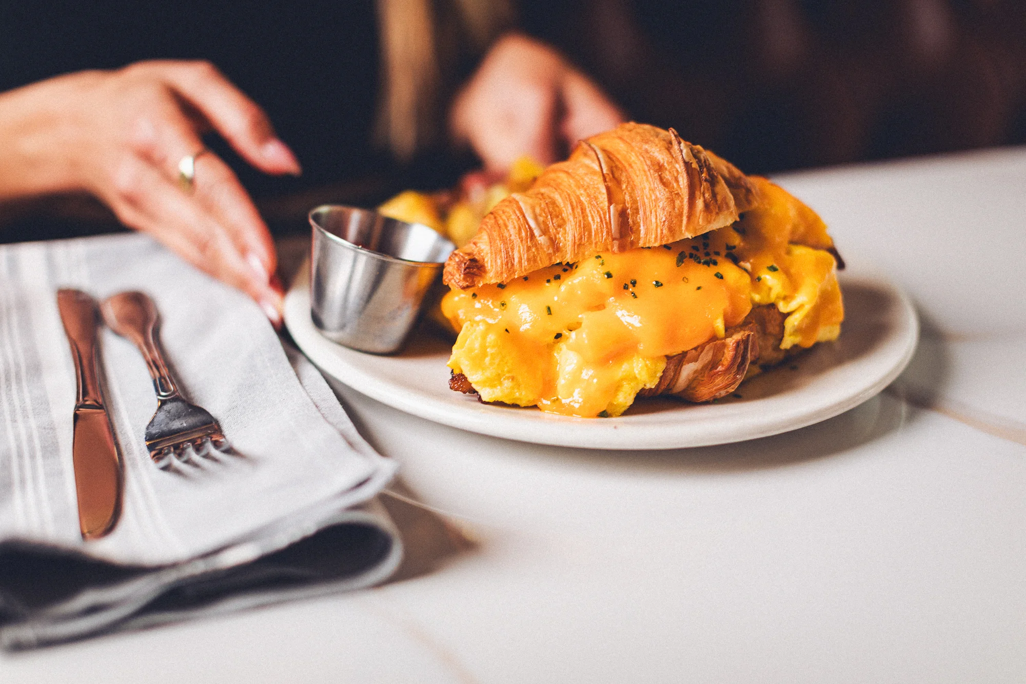 Cheesy croissant sandwich with scrambled eggs