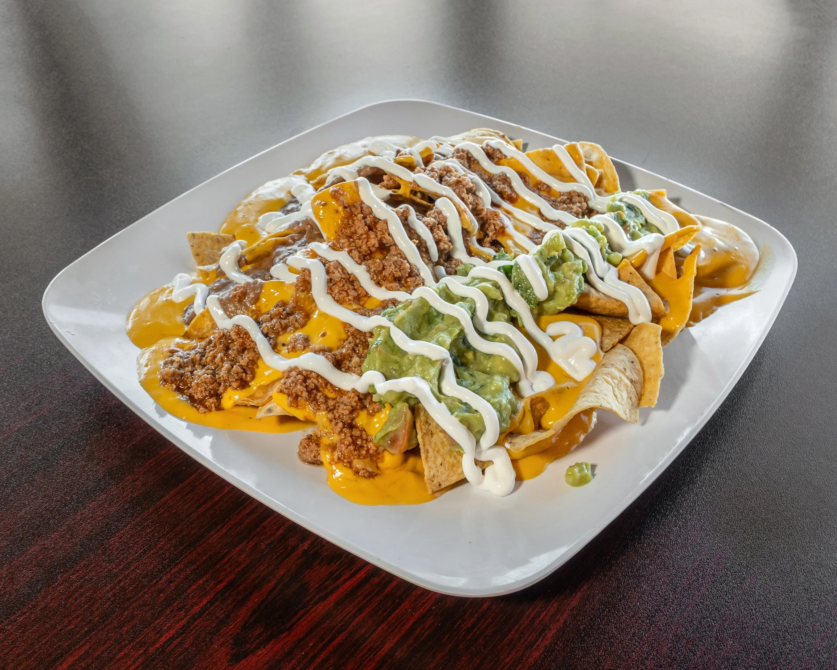 Delicious nachos topped with cheese, jalapeños, and fresh toppings.