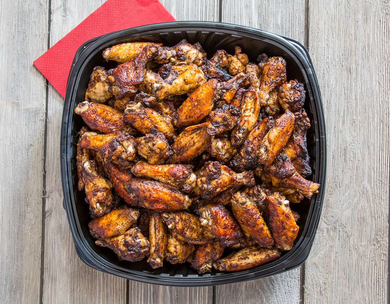 Crispy Southern-style chicken wings served in a black tray