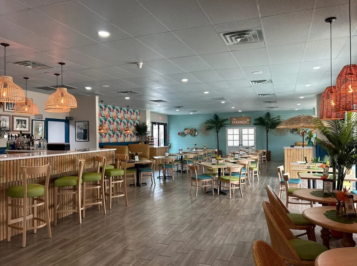 Bright tropical restaurant interior with woven pendant lights and colorful dining area