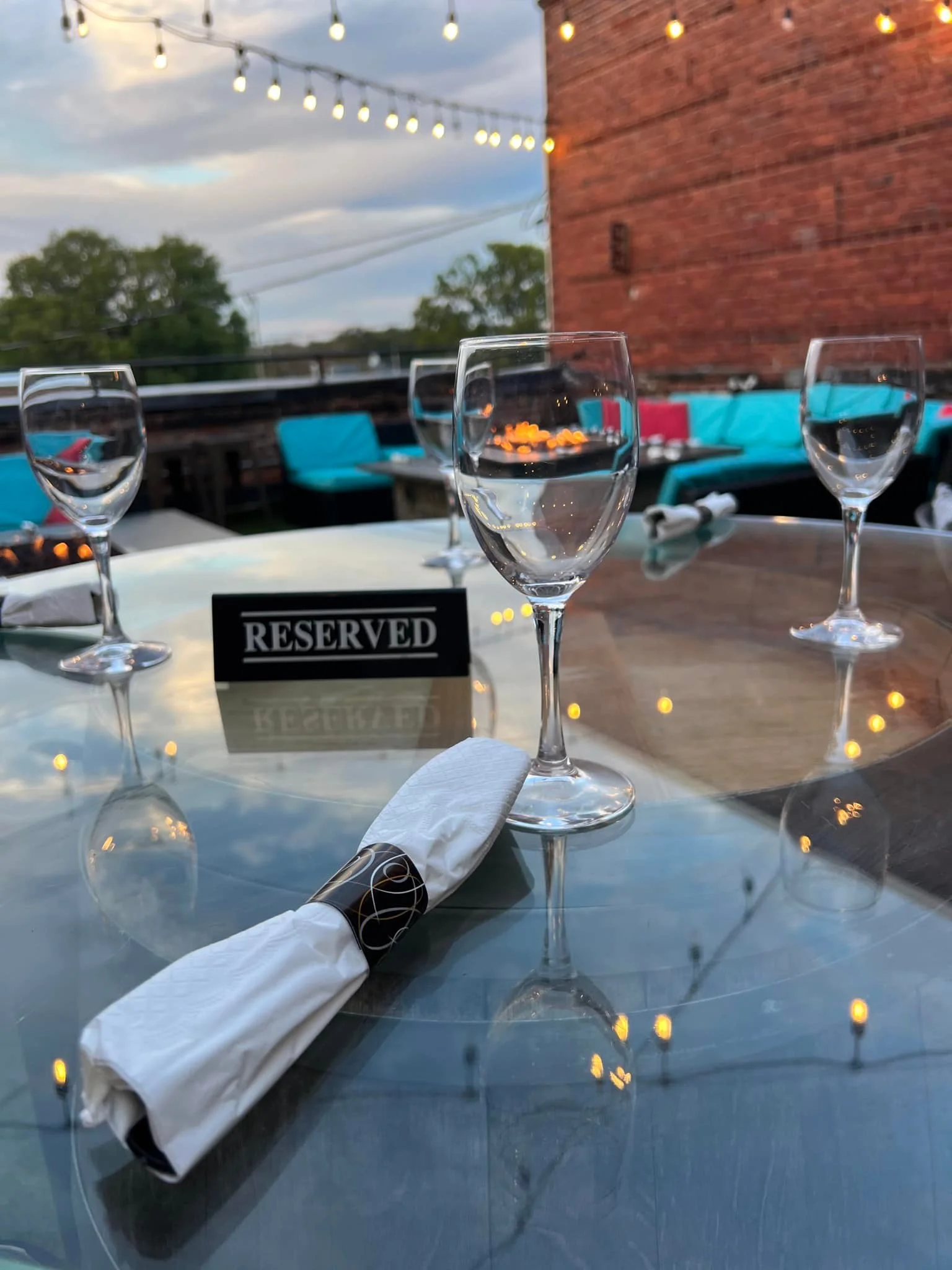 Reserved dining table with elegant glassware and cozy outdoor ambiance