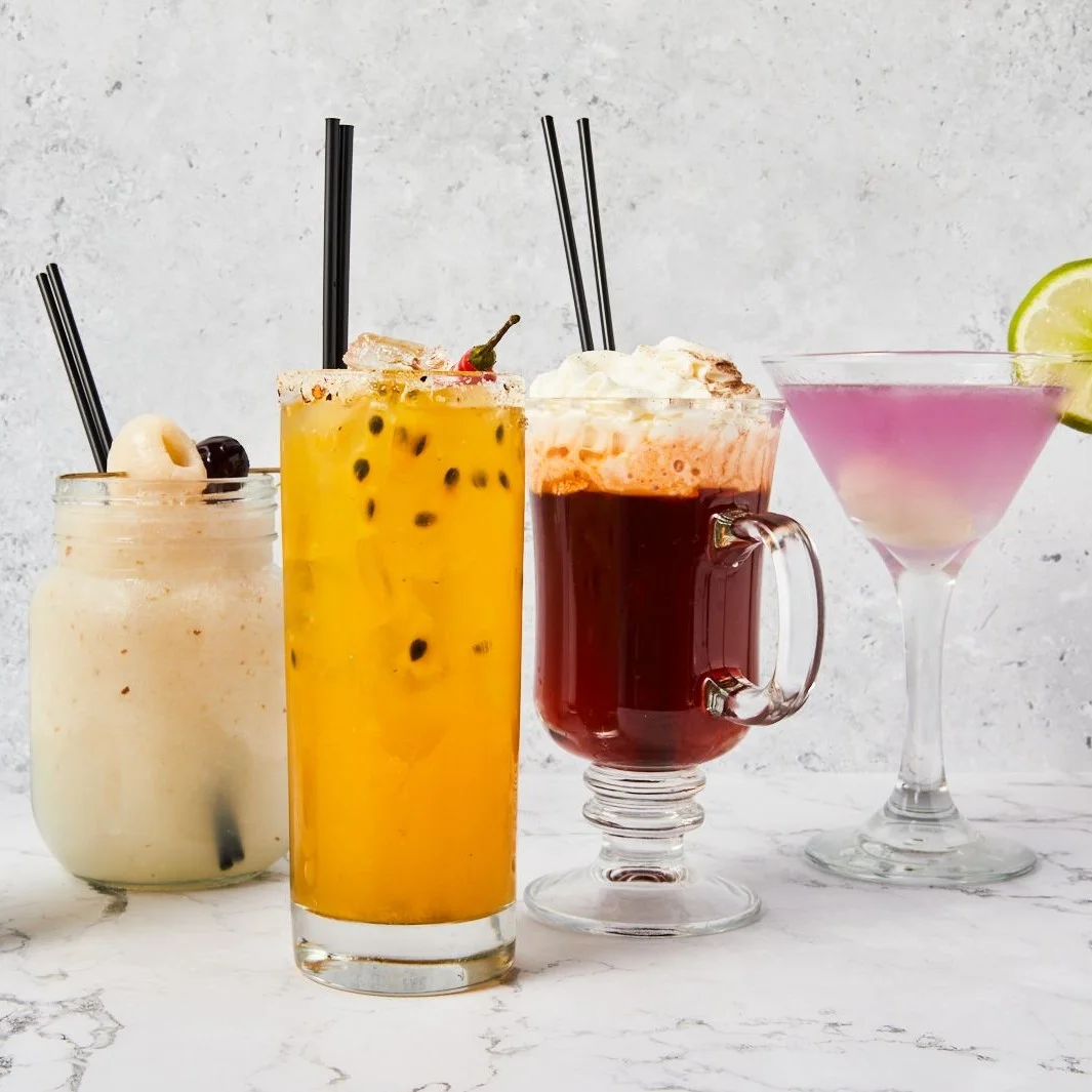 Colorful cocktails in various glasses on a marble surface