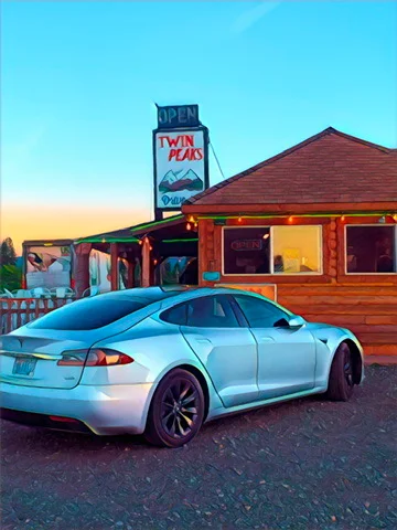 Exterior view of Twin Peaks restaurant with a silver car parked
